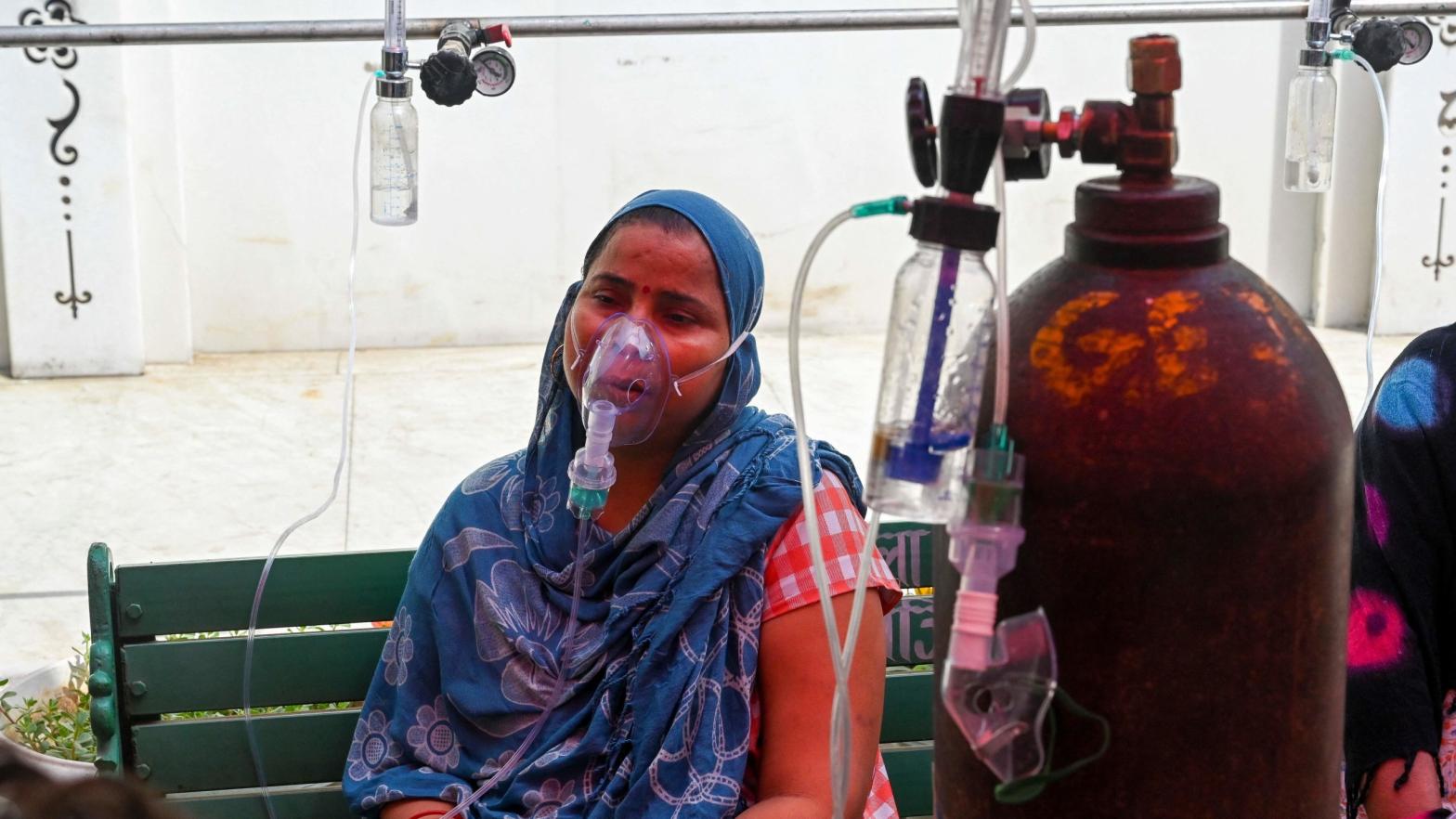 A covid-19 patient breathes with the help of oxygen provided by a Gurdwara, a place of worship for Sikhs, under a tent installed along the roadside in Ghaziabad, India on April 28, 2021.  (Photo: Prakash Singh/AFP, Getty Images)