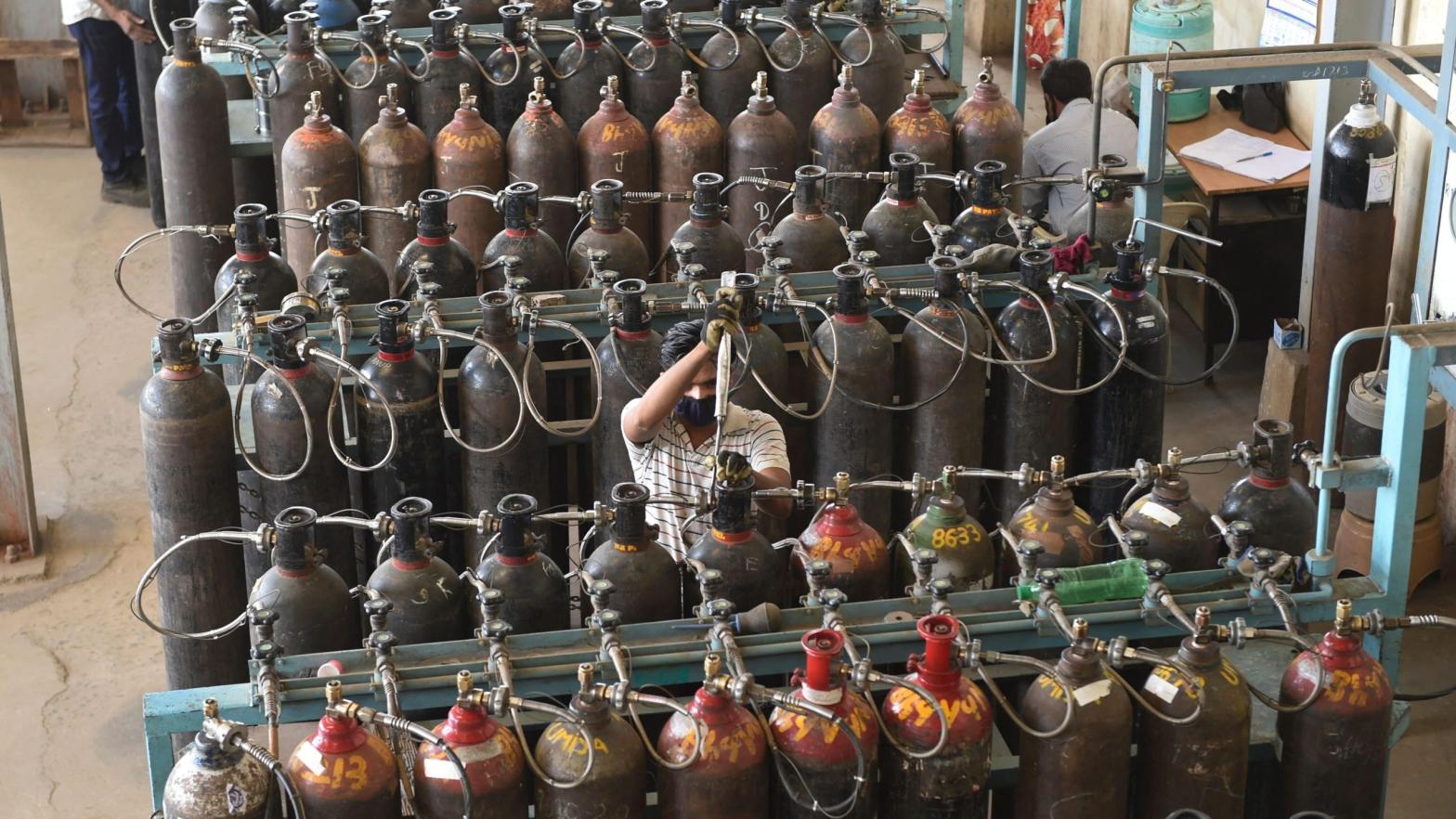 Technicians monitor medical oxygen refilling lines at a supply plant in Ahmedabad, India on May 3, 2021. (Photo: Sam Panthaky/AFP, Getty Images)