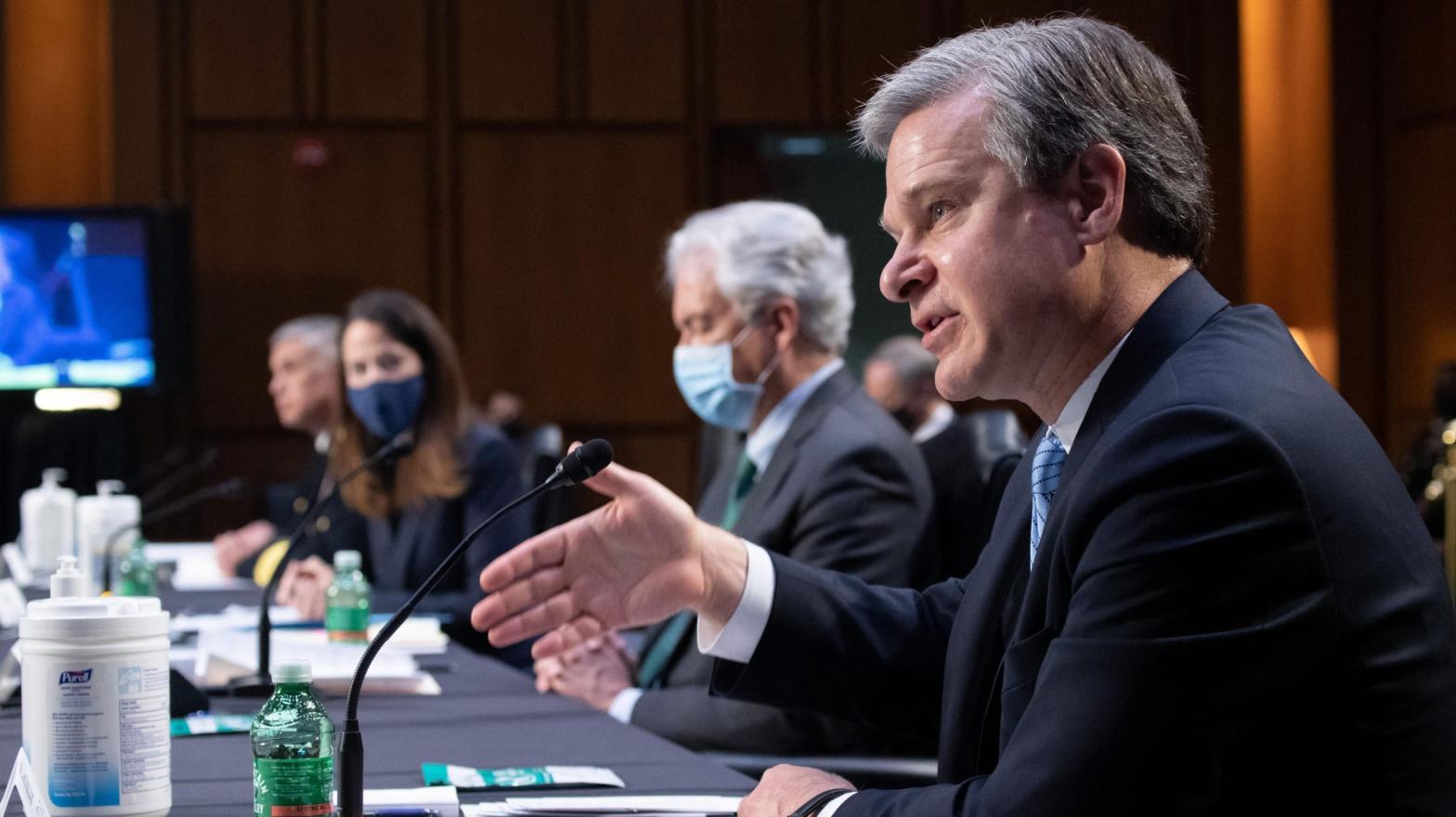 FBI Director Christopher Wray (R) testifies during a Senate Select Committee on Intelligence hearing about worldwide threats, on Capitol Hill in Washington, DC, April 14, 2021. (Photo: Saul Loeb, Getty Images)
