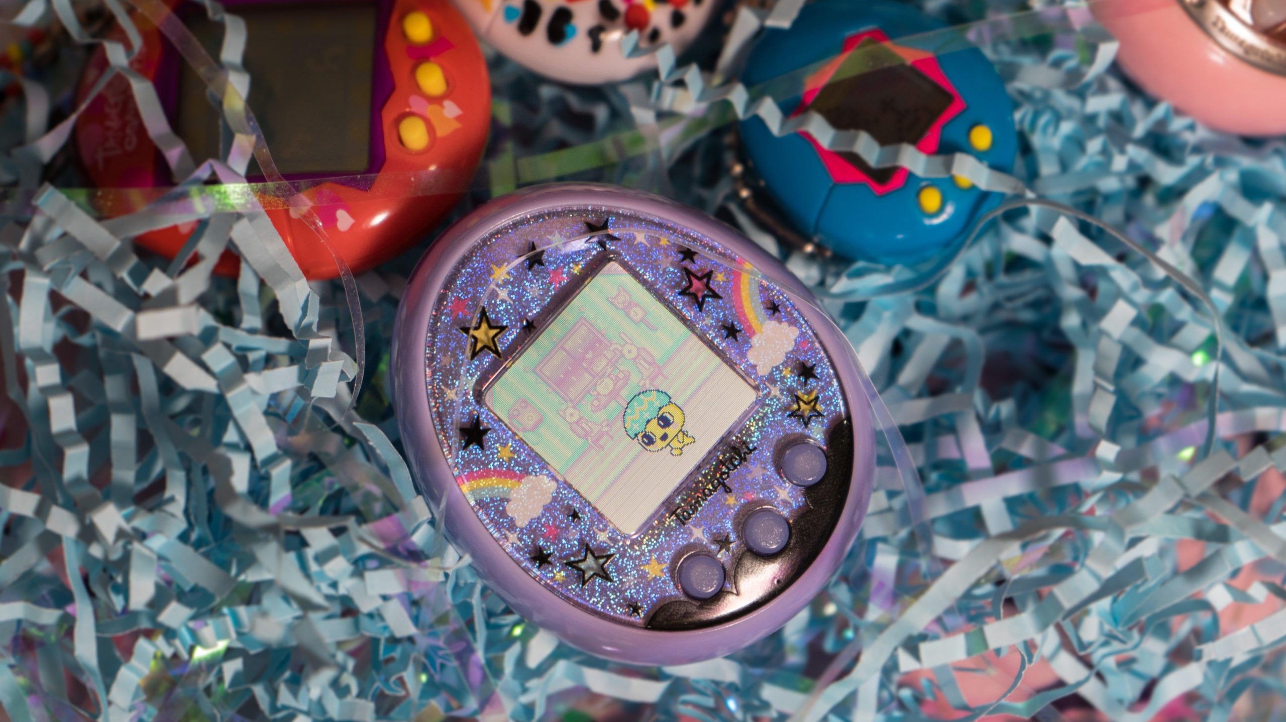 My Tamagotchi On, surrounded by its adopted siblings.  (Photo: Florence Ion/Gizmodo)