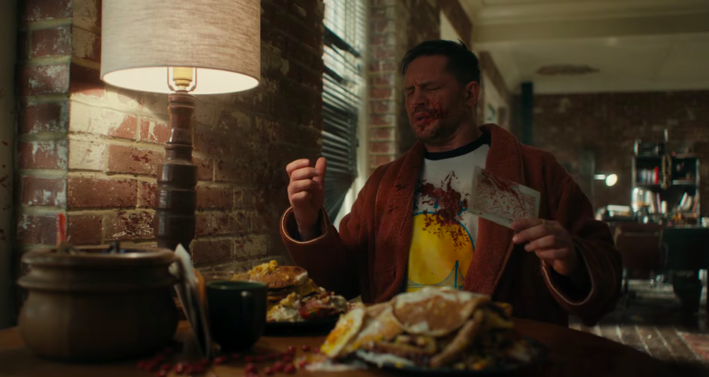 Eddie Brock, with ketchup on his face. (Screenshot: Sony)