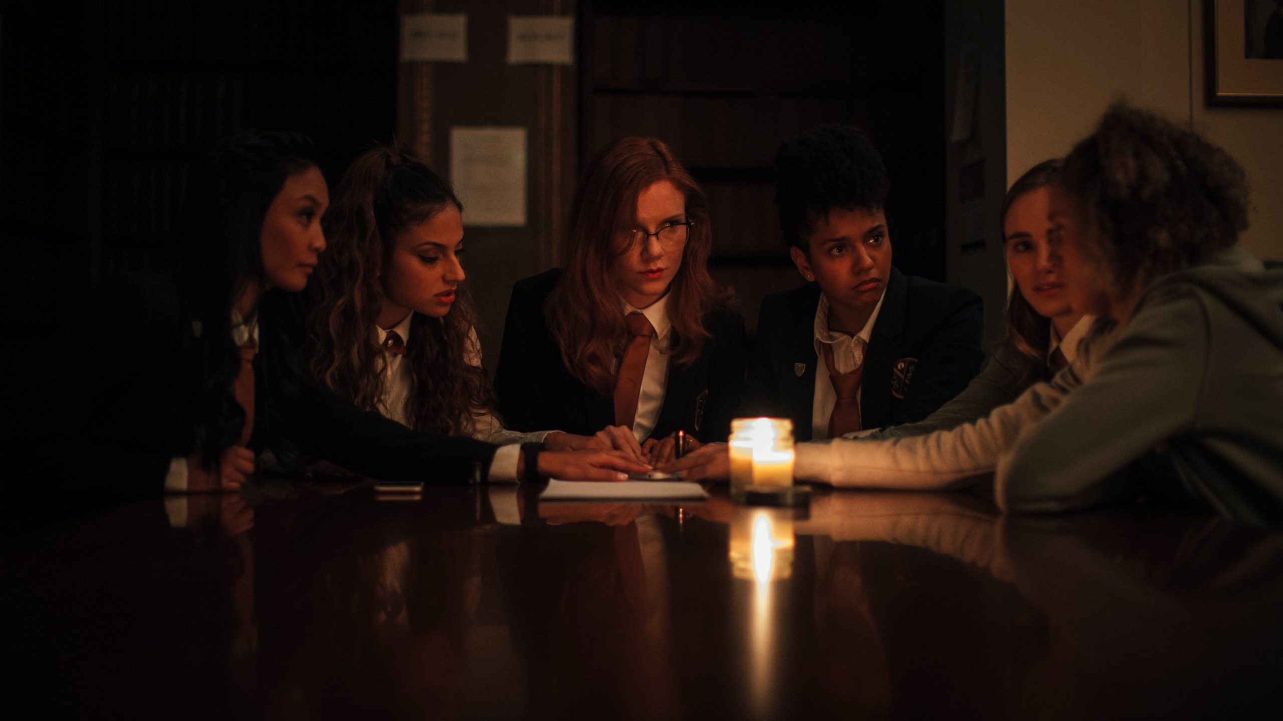 The girls reach out into the spirit realm. (Image: RJLE Films/Shudder)