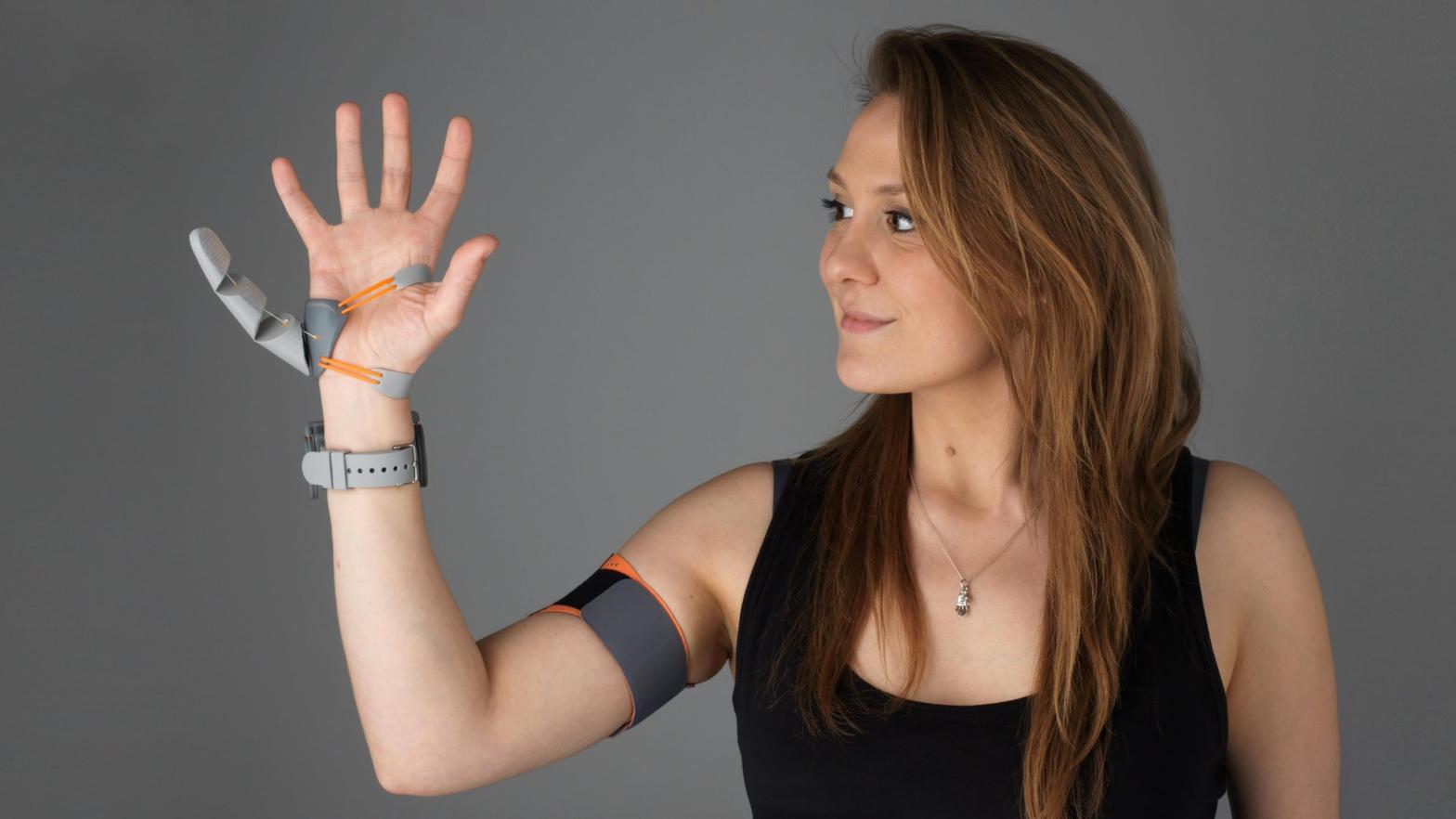 UCL designer Dani Clode with her 'Third Thumb' device. (Image: Dani Clode)