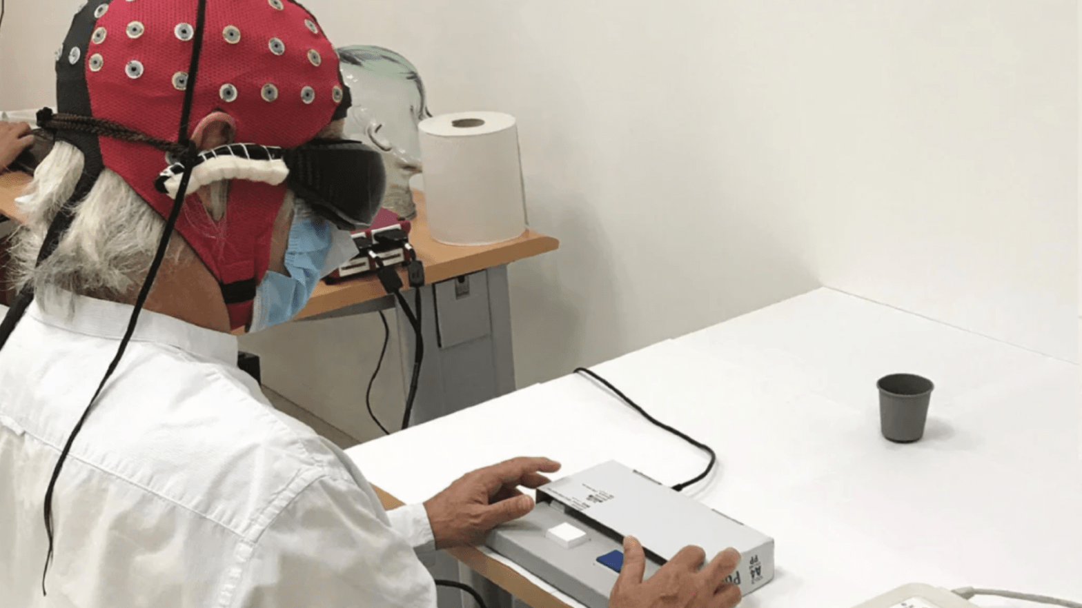 One of the study's researchers demonstrating the set-up used to confirm the success of the gene therapy treatment, including the use of specialised goggles seen above.  (Image: Sahel, et al., Nature Medicine)