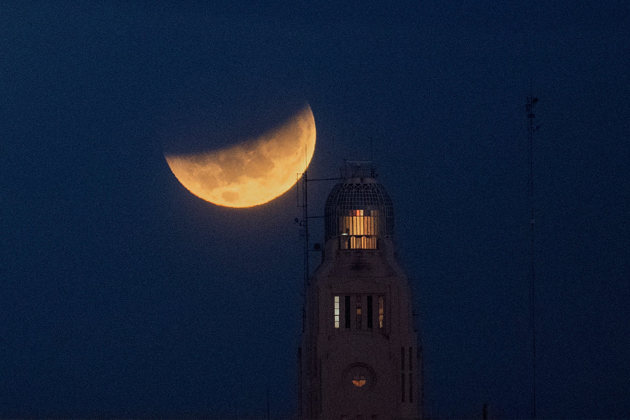 The moon sets behind the Montevideo port, in Uruguay, Wednesday, May 26, 2021. (Photo: Matilde Campodonico, AP)