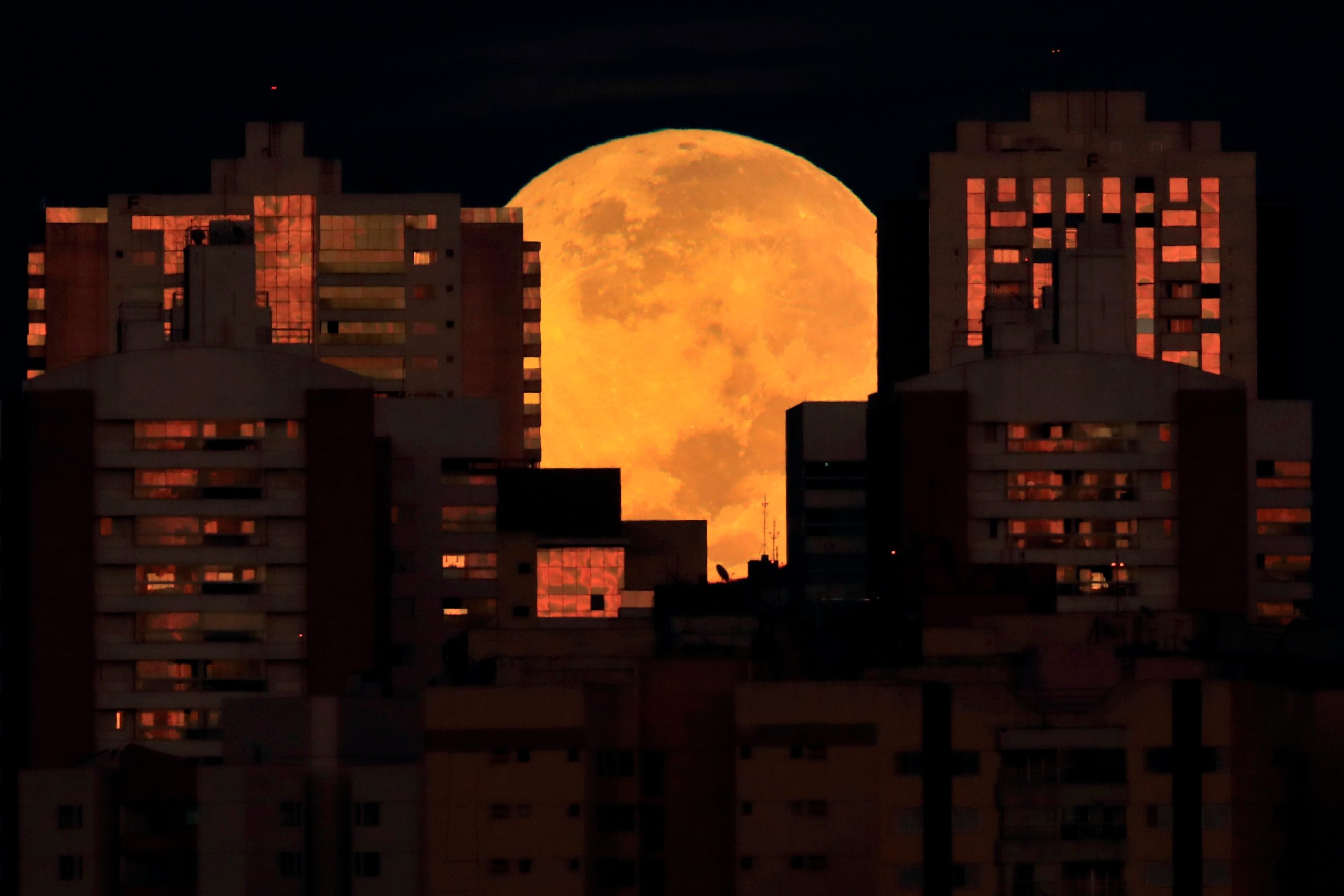 The moon is partiasanlly covered by buildings in Brasilia, Brazil, at the  start of a total lunar eclipse early Wednesday, May 26, 2021. (Photo: Eraldo Peres, AP)