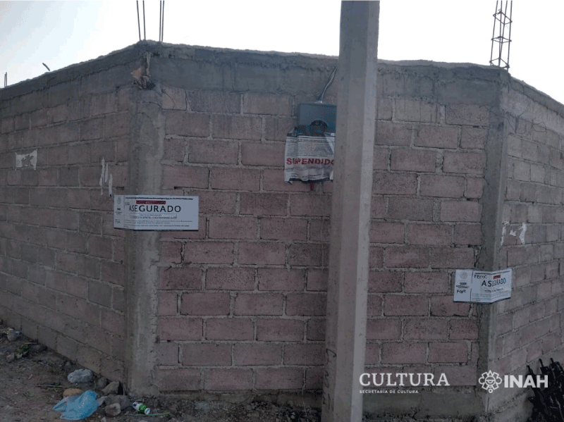 Walls of the construction site, with ministry labels now declaring the area secured. (Image: Ministry of Culture/INAH)