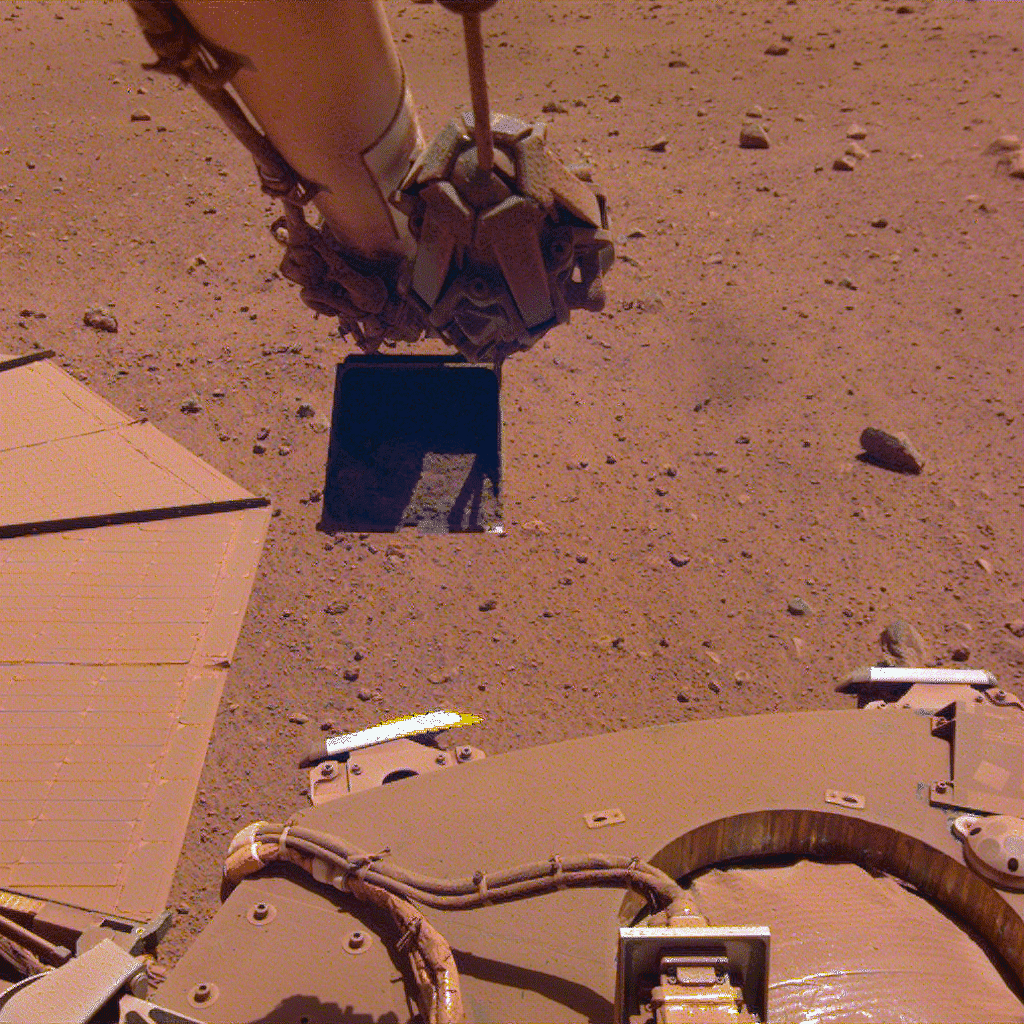 InSight's robotic arm flexing, with a dusty solar panel at left. (Gif: NASA/JPL-Caltech)