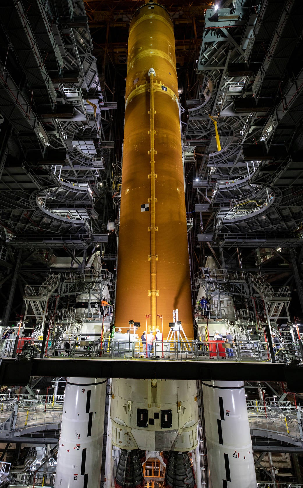 The core stage being lowered onto the mobile launcher, with the twin booster rockets at each side.  (Image: NASA/Cory Huston)