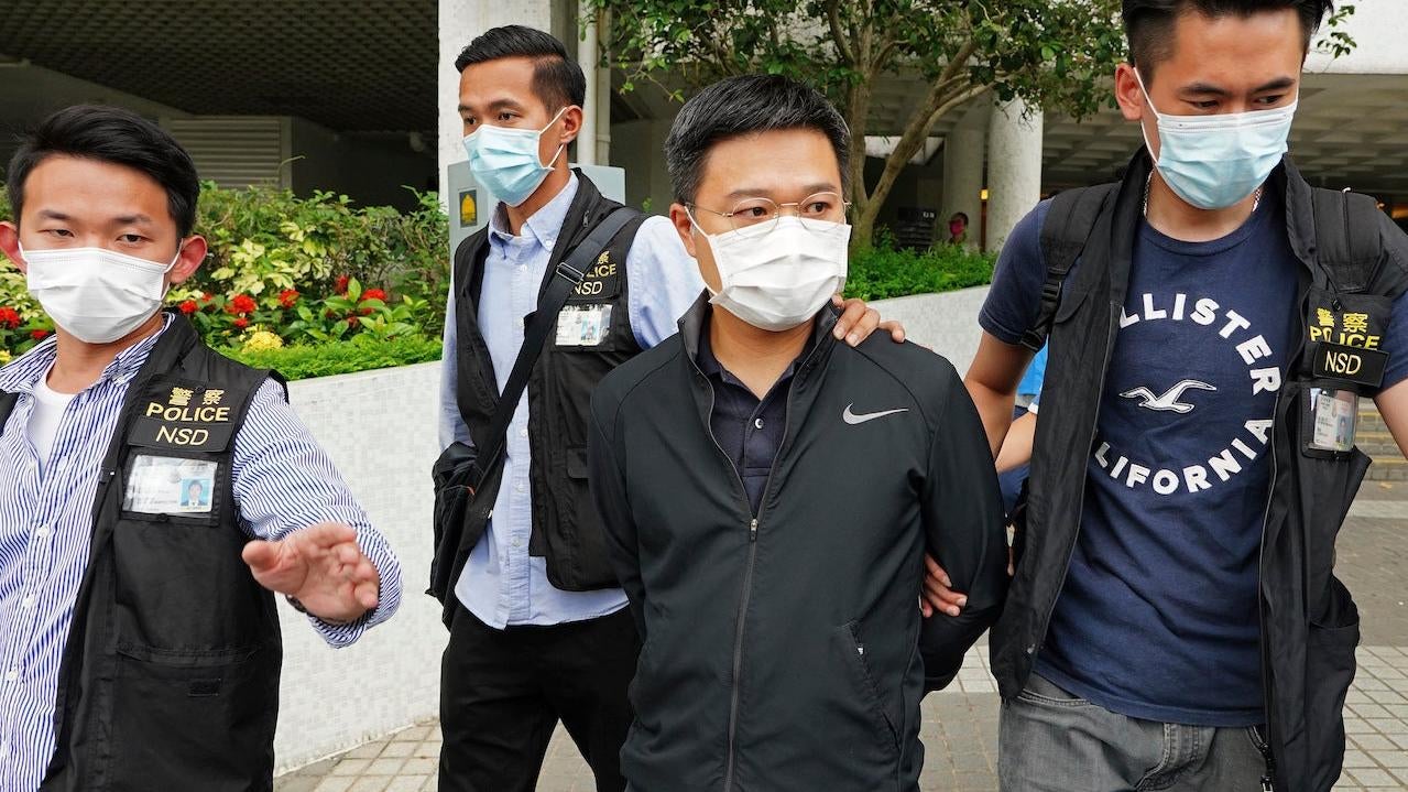 Ryan Law, second from right, Apple Daily's chief editor, is arrested by police officers in Hong Kong Thursday, June 17, 2021. (Photo: AP Photo, AP)