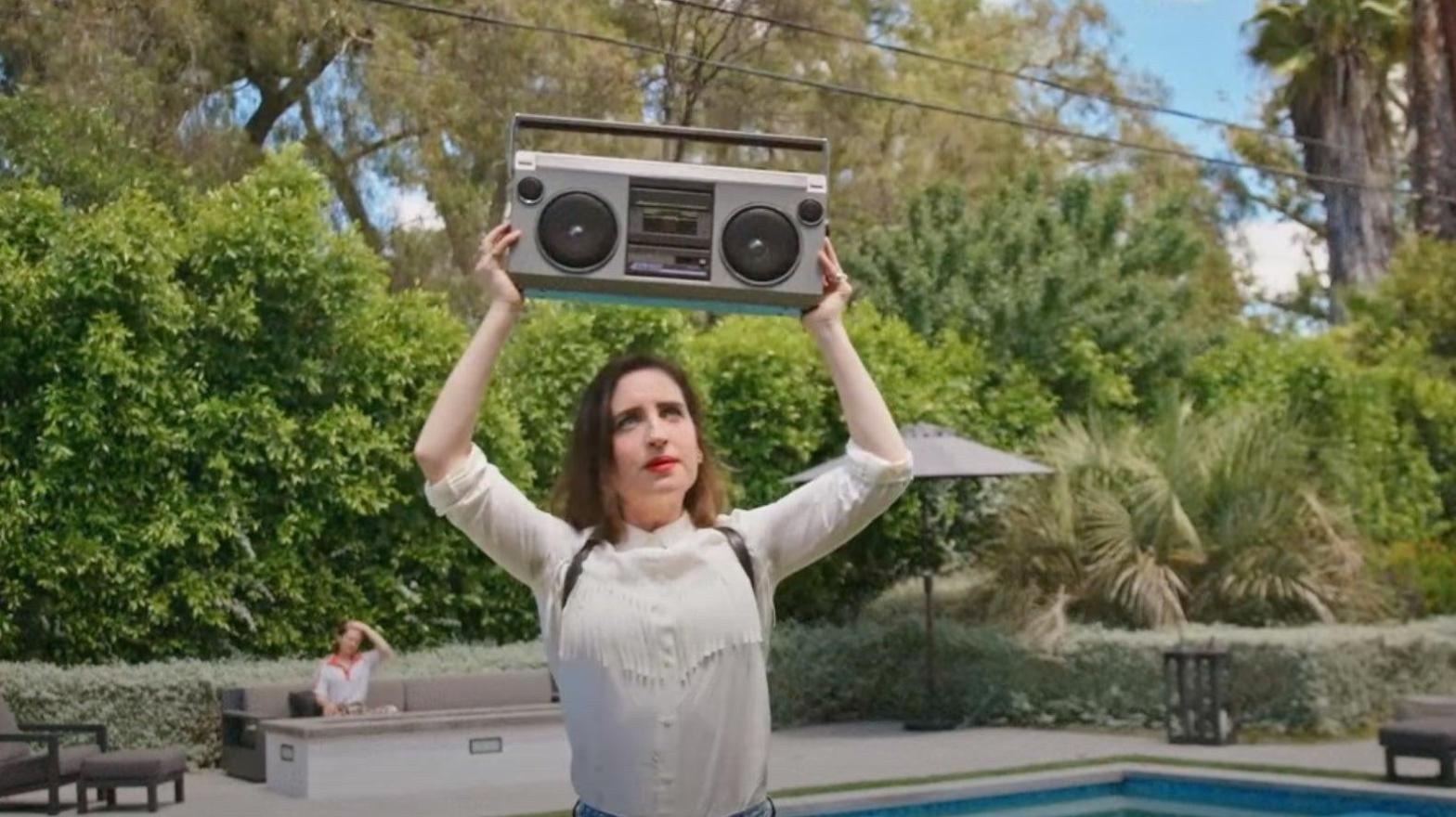Zoe Lister-Jones doing a John Cusack impression in How It Ends. (Screenshot: MGM)