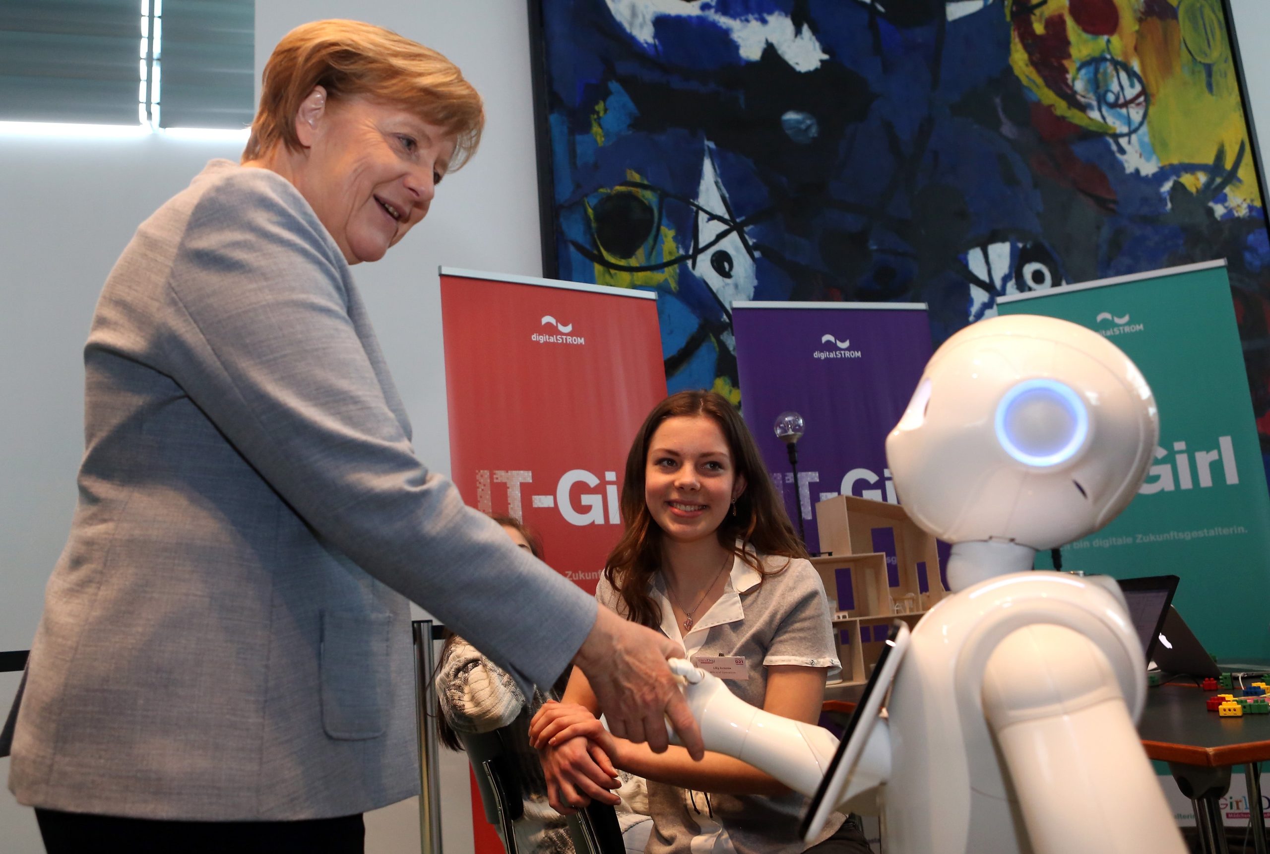 German Chancellor Angela Merkel is introduced to Pepper the Robot by participant Lilly Antonia on Girls' Day on April 26, 2017 in Berlin, Germany. (Photo: Adam Berry, Getty Images)