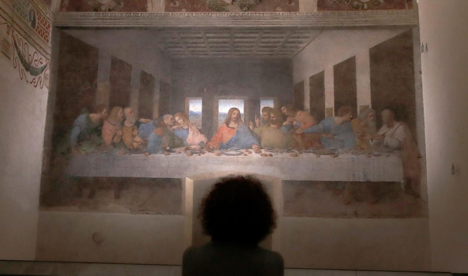 A woman studying Leonardo da Vinci's painting, The Last Supper. (Image: Antonio Calanni, AP)