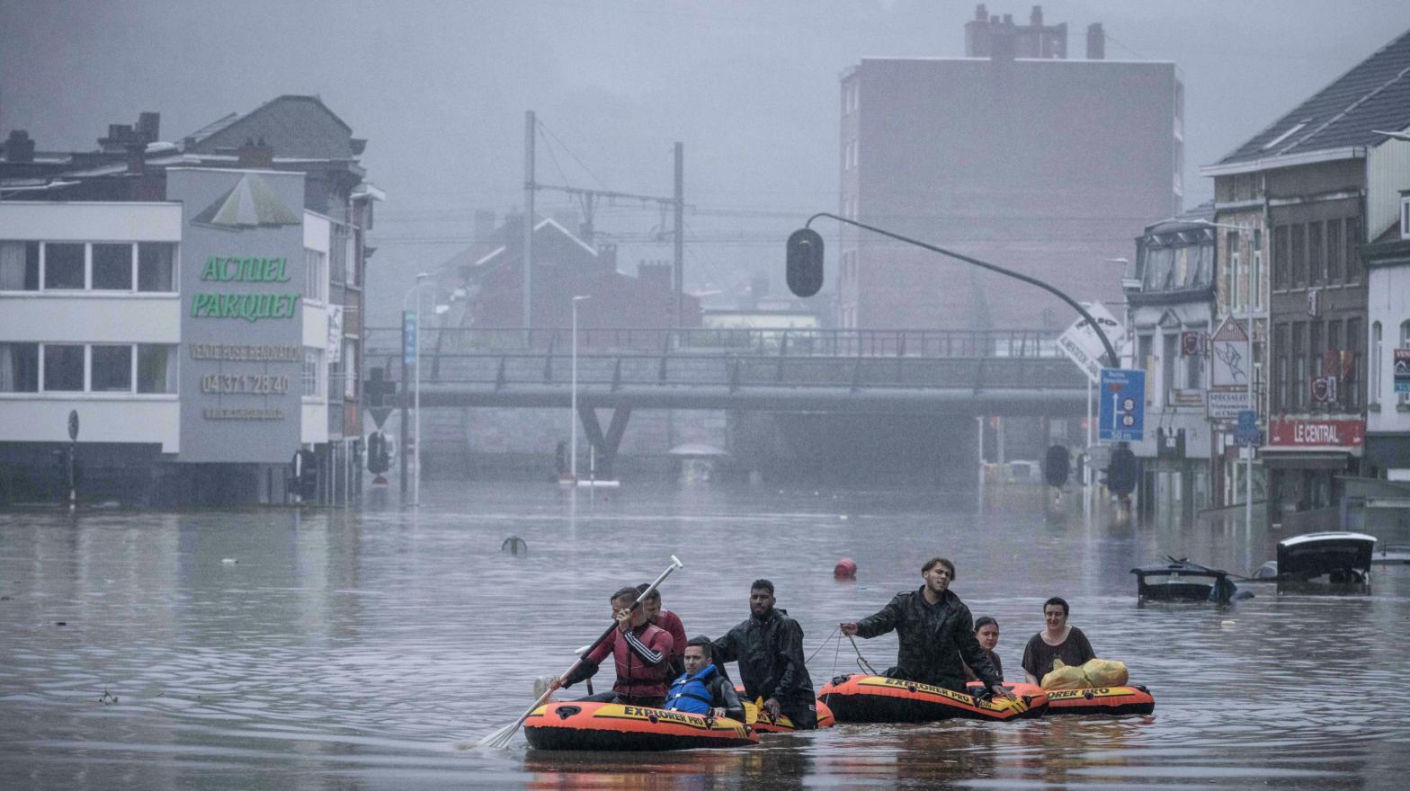 People use rubber rafts in floodwaters after the Meuse River broke its banks during heavy flooding in Liege, Belgium, Thursday, July 15. (Photo: Valentin Bianchi, AP)