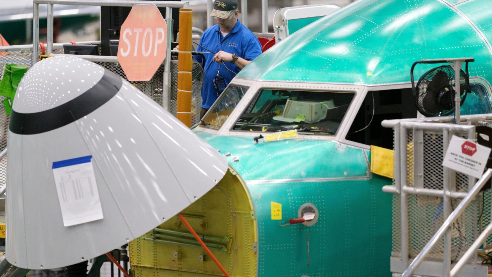 A Boeing factory worker working outside the cockpit of a 737 Max 8 under production at the company's Renton, Washington plant in March 2019. (Photo: Stephen Brashear, Getty Images)