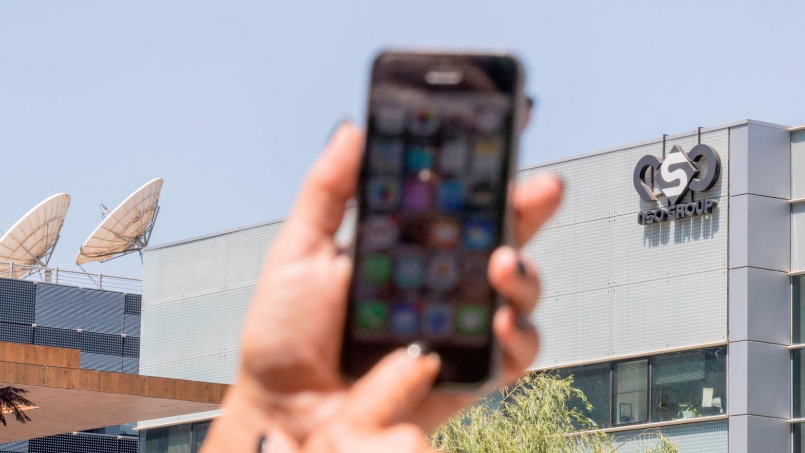 An Israeli woman uses her iPhone in front of the building housing the Israeli NSO group, on August 28, 2016, in Herzliya, near Tel Aviv.  (Photo: Jack Guez / AFP, Getty Images)