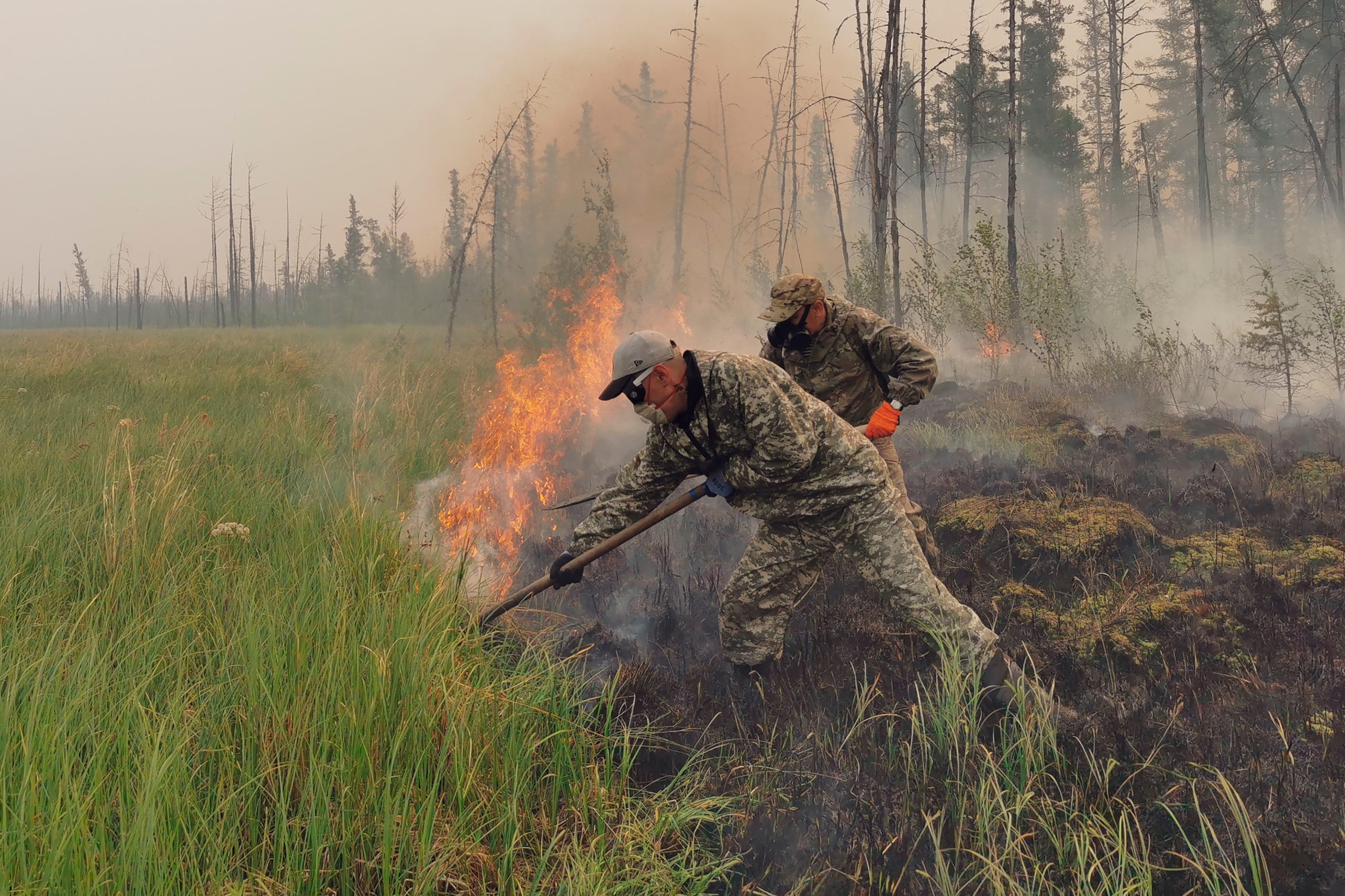 Volunteers douse a forest fire in the republic of Sakha also known as Yakutia, Russia Far East, Saturday, July 17, 2021. (Photo: Ivan Nikiforov, AP)