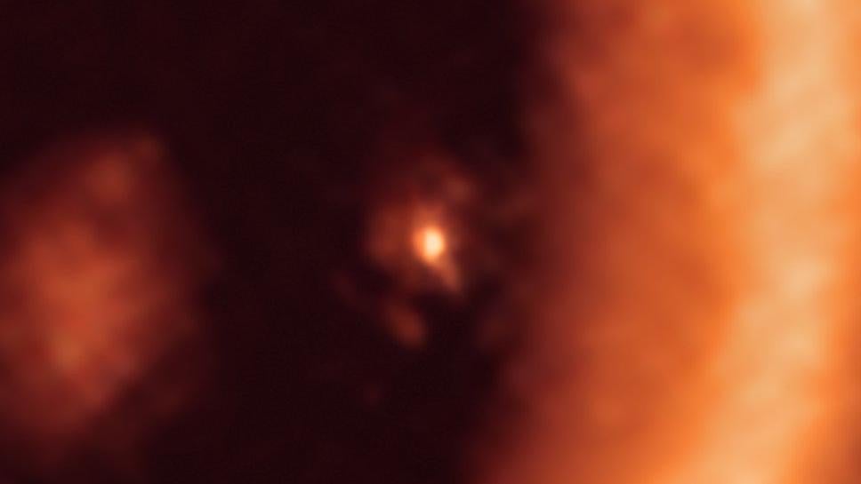 At centre, the circumplanetary disk surrounding the giant protoplanet. The larger circumstellar ring dominates the right-hand portion of the ALMA image.  (Image: ALMA (ESO/NAOJ/NRAO)/Benisty et al.)