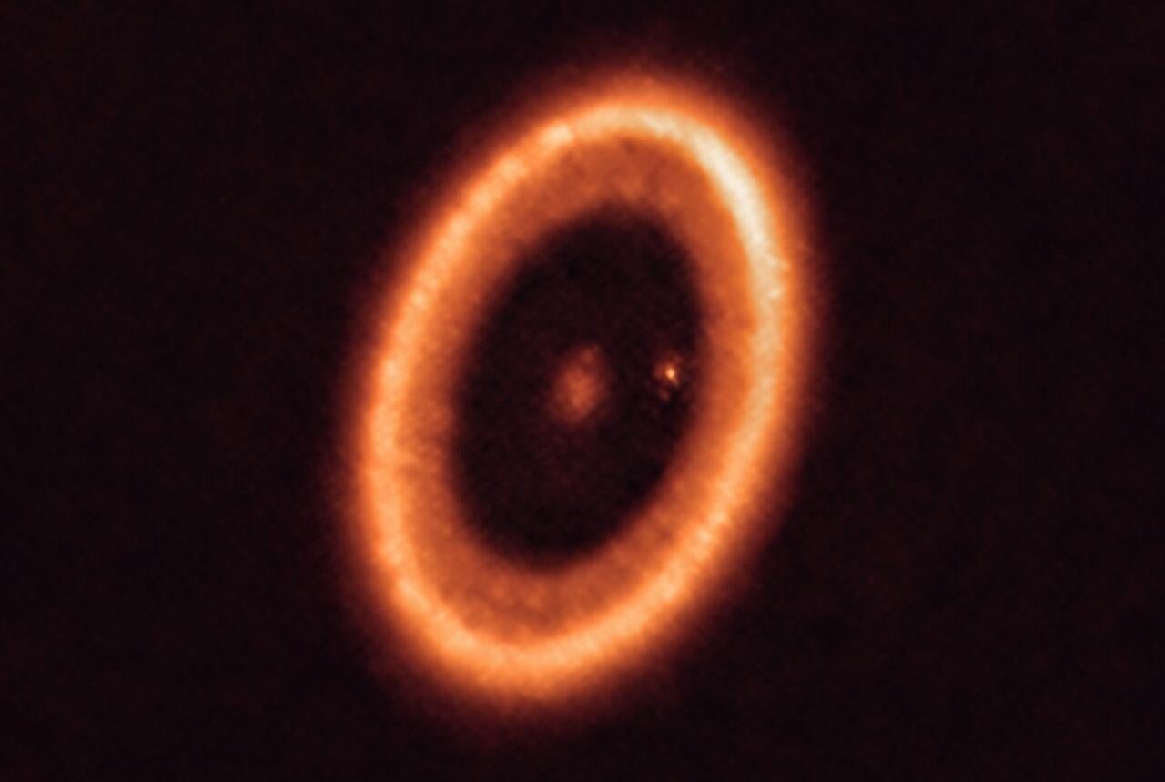 The PDS 70 system as imaged by ALMA. It shows the doughnut-like circumstellar disk surrounding the host star, and the protoplanet tucked away along the inside right.  (Image: ALMA (ESO/NAOJ/NRAO)/Benisty et al.)