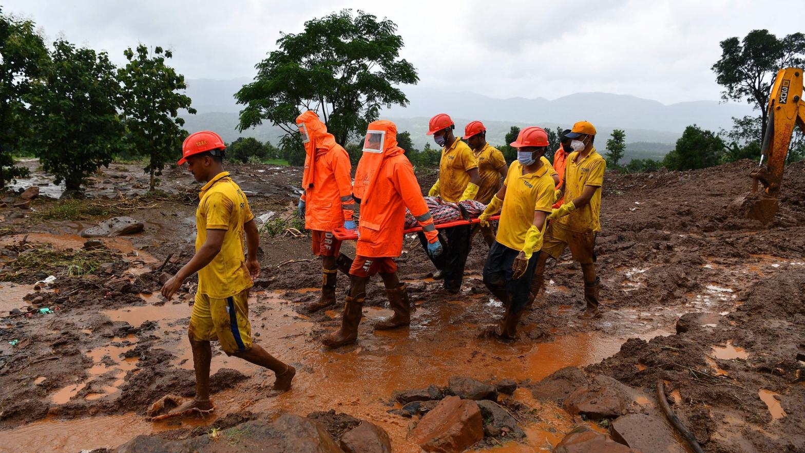 Emergency personnel carry the body of a victim at the site of a landslide at Taliye, a village in India about 110 miles (180 kilometers) southeast of Mumbai, on July 24, 2021. (Photo: Indranil Mukherjee, Getty Images)
