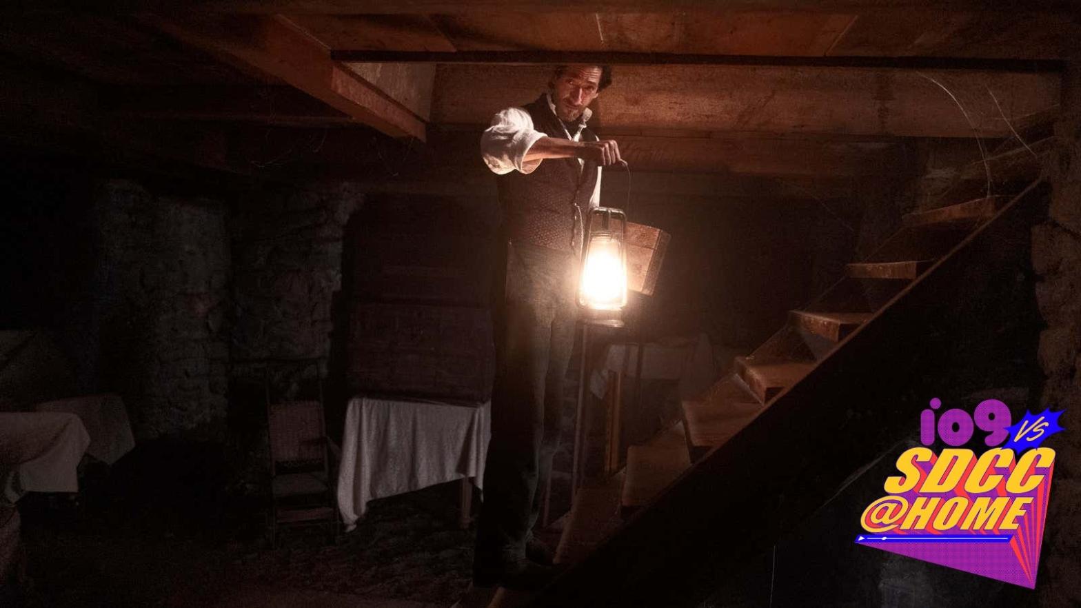 A lantern-toting Captain Charles Boone (Adrien Brody) is surrounded by darkness in Chapelwaite. (Image: Chris Reardon/Epix)