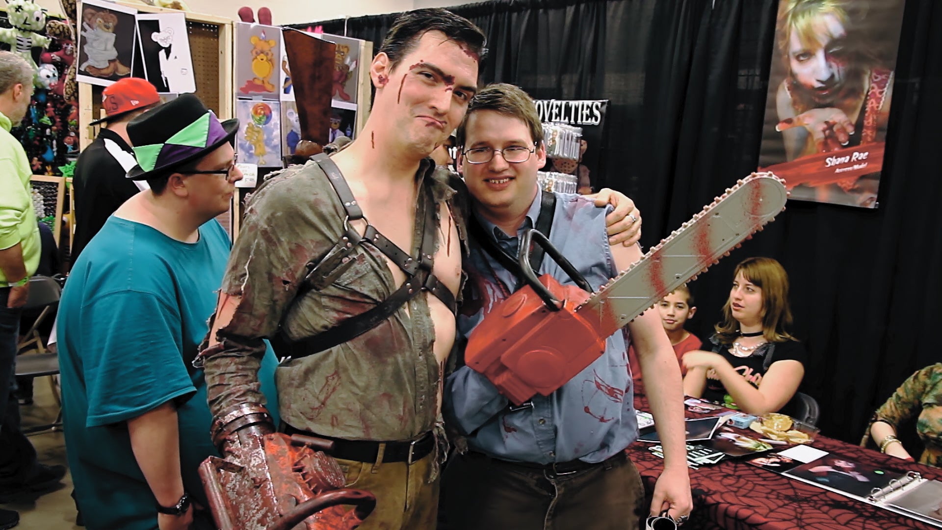 A cosplayer dressed as Ash poses with an admirer at a horror convention. (Image: Shout Studios)