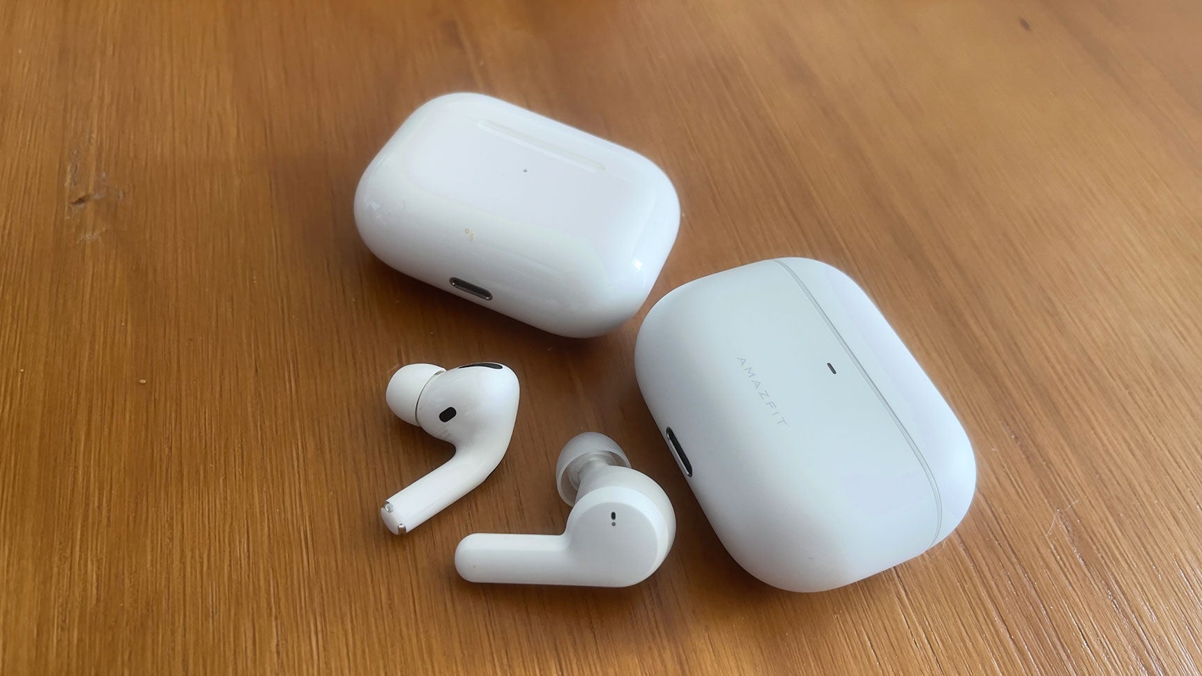 There's definitely a difference between the Powerbuds and AirPods Pro up close, but you can see how they look very similar at a glance. (Photo: Victoria Song/Gizmodo)