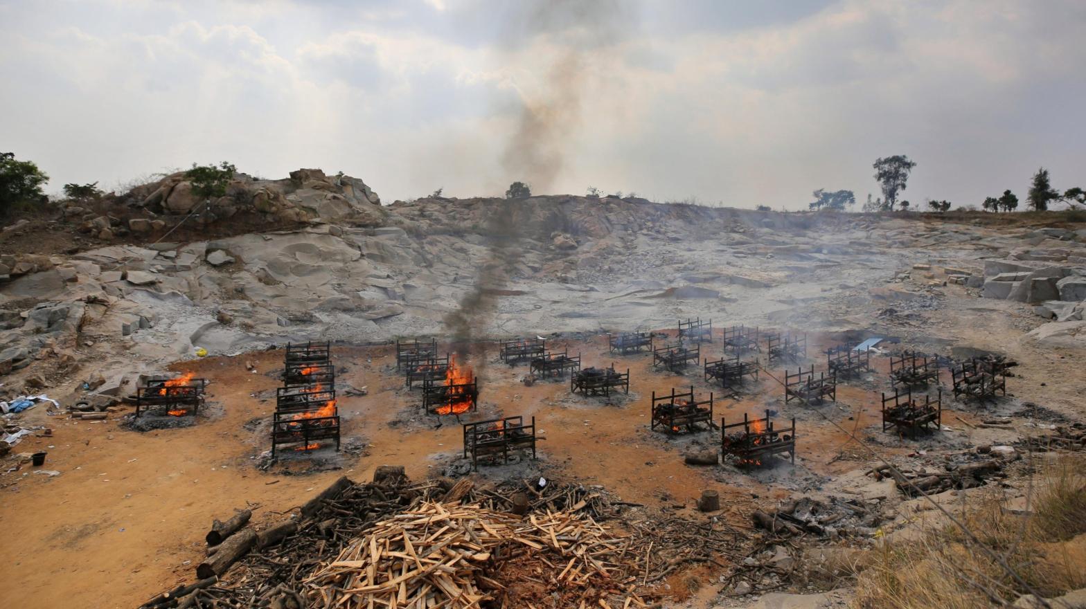 Funeral pyres for 25 separate people burn at a granite quarry near Bengaluru, India, in May 2021. (Photo: Aijaz Rahi / File, AP)
