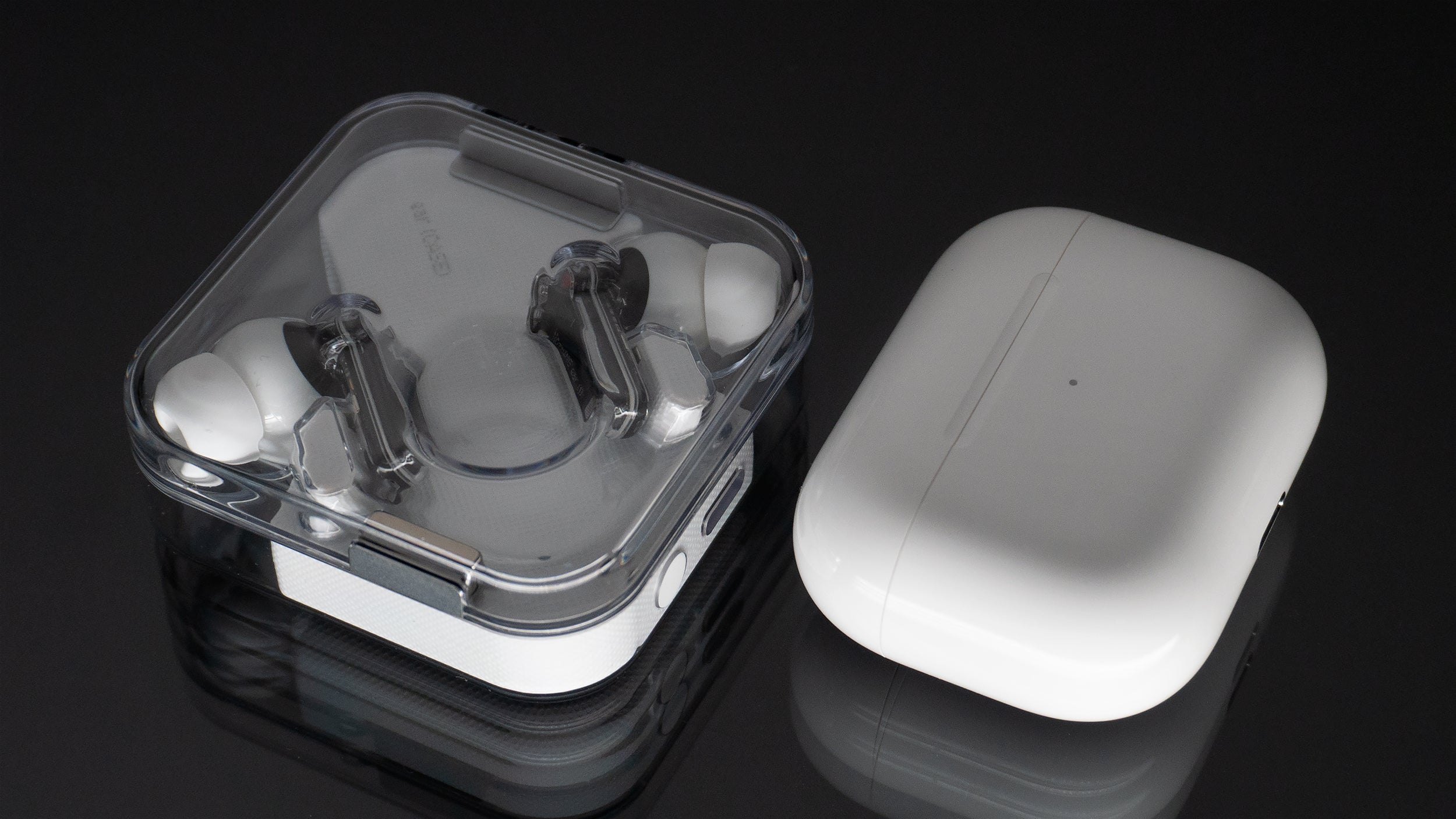 The ear (1) charging case is a bit on the bulky side, but it gives the earbuds up to 34 hours of playback time when away from a power source, compared to 24 hours in total with the AirPods Pro's charging case. (Photo: Andrew Liszewski - Gizmodo)