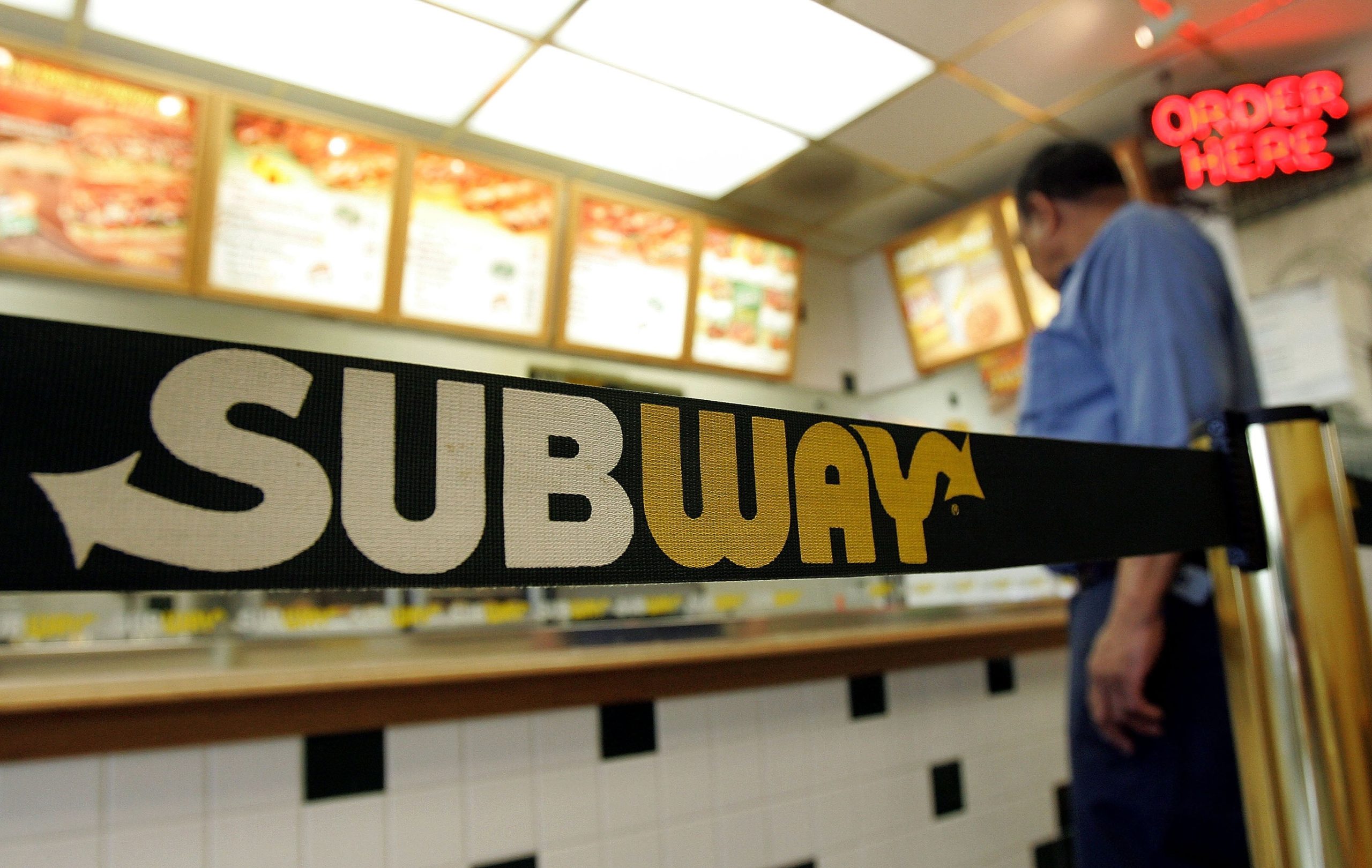 A person stands near signage while inside a Subway restaurant June 6, 2005, in Chicago, Illinois. (Photo: Tim Boyle, Getty Images)