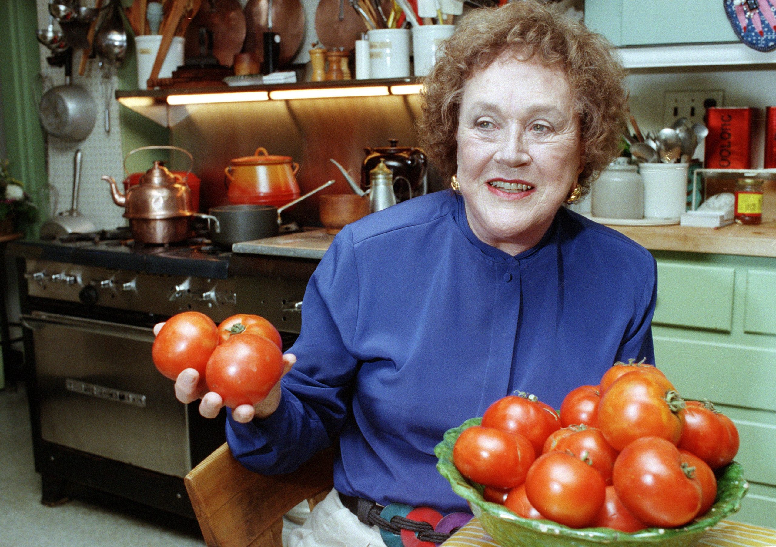 In this Aug. 13, 1992 photo, chef and author Julia Child holds tomatoes in the kitchen of her home in Cambridge, Mass. (Photo: Jon Chase, AP)
