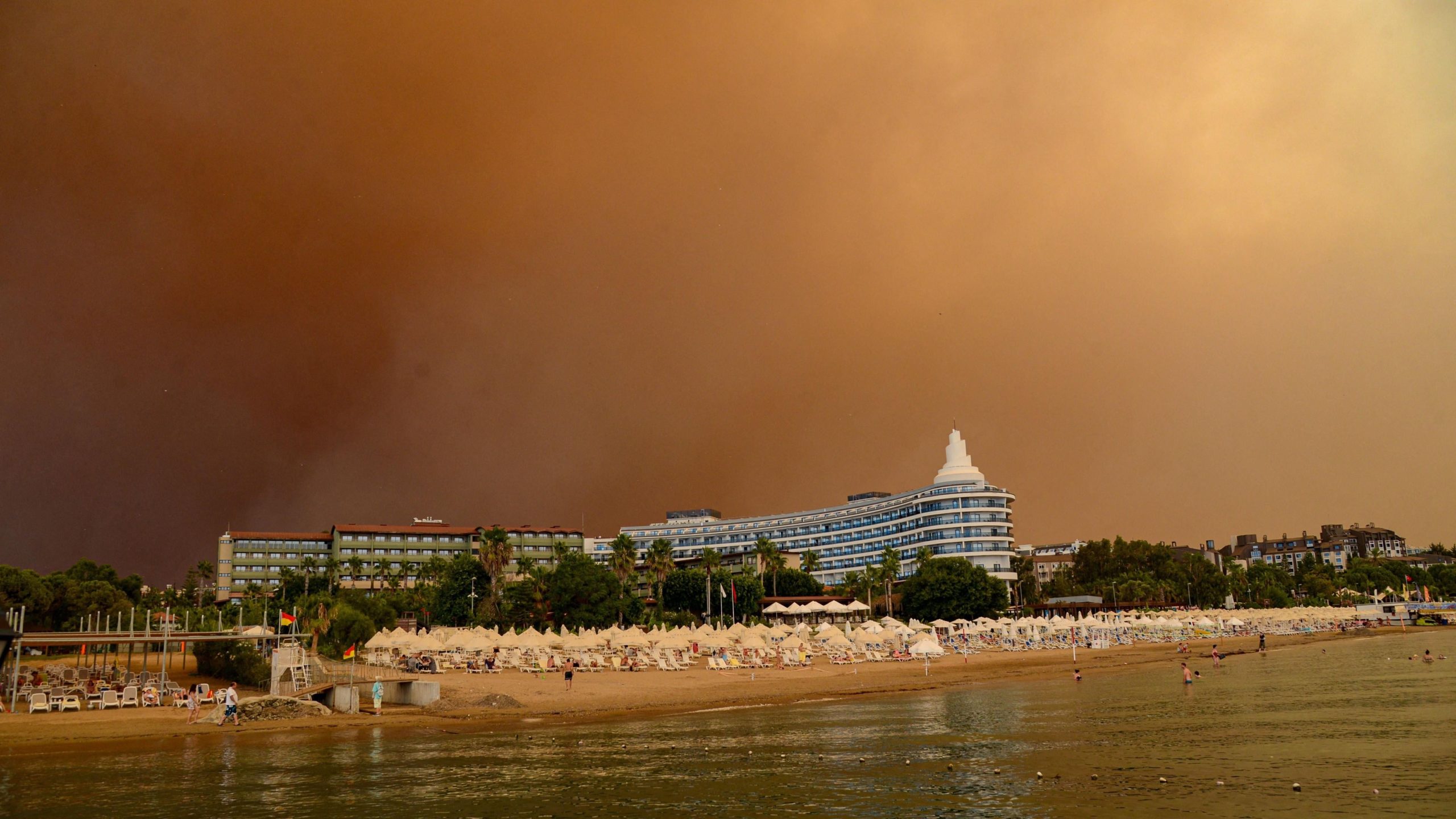 Dark smoke drifts over a hotel complex during a massive forest fire which engulfed a Mediterranean resort region on Turkey's southern coast near the town of Manavgat, on July 29, 2021. (Photo: Ilyas Akengin/AFP, Getty Images)