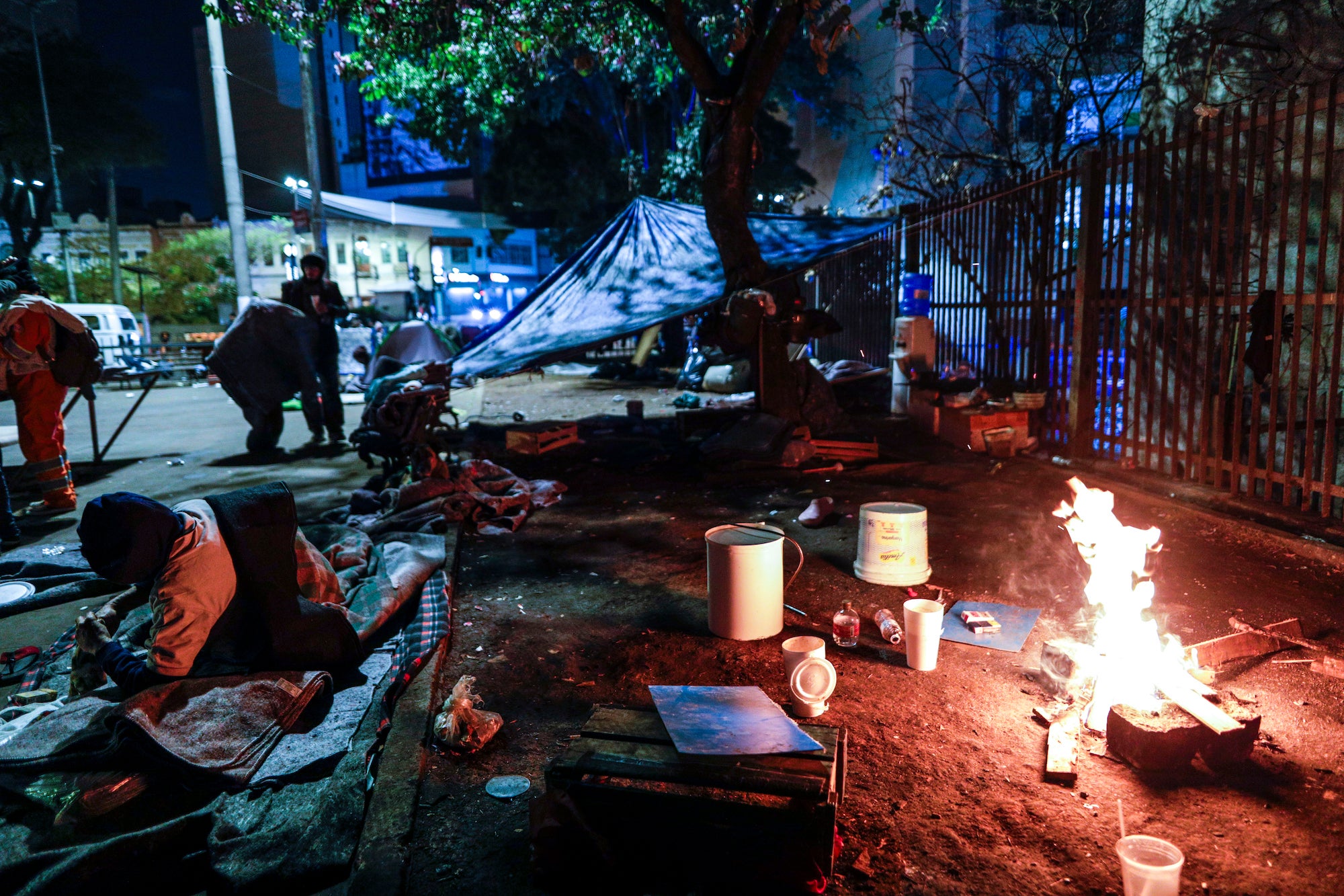 Unhoused people light a fire to stay warm during a cold night in Sao Paulo, Brazil, Thursday, July 29, 2021. (Photo: Marcelo Chello, AP)
