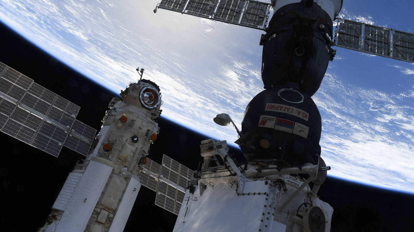 The Nauka module (left) docked to the ISS, with a Soyuz spacecraft (right) parked nearby.  (Image: Roscosmos)