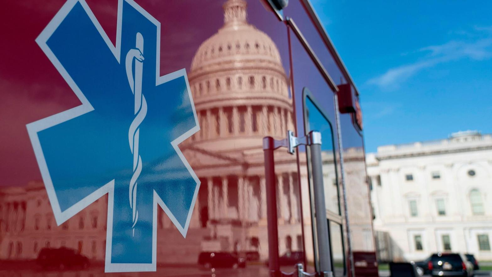 The US Capitol is reflected in a standby ambulance on March 27, 2020, in Washington, DC.  (Photo: Alex Edelman, Getty Images)