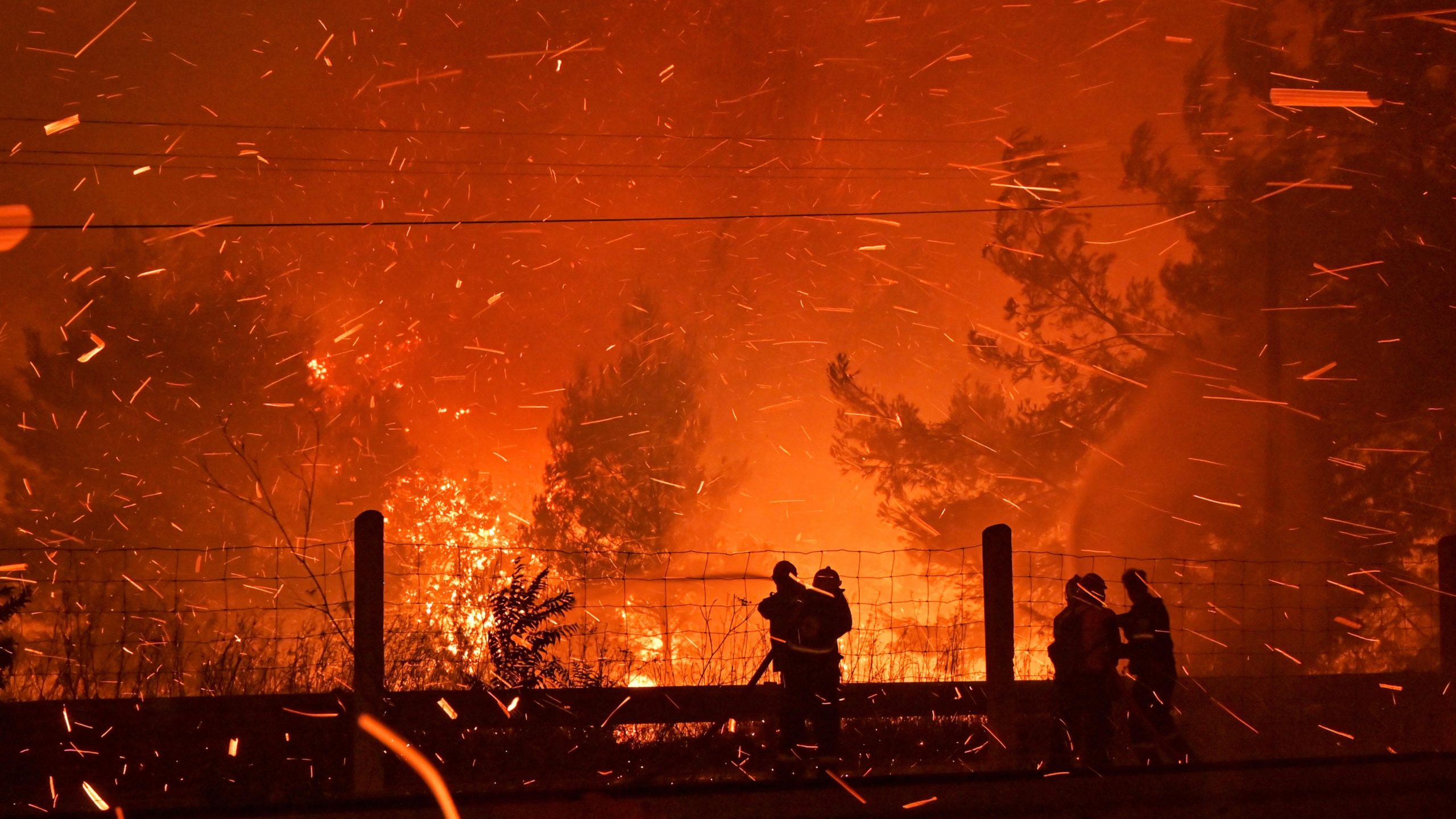 Firefighters try to put out a wildfire as flames spread over a highway on August 5, 2021, in northern Athens, Greece. (Photo: Milos Bicanski/Stringer, Getty Images)