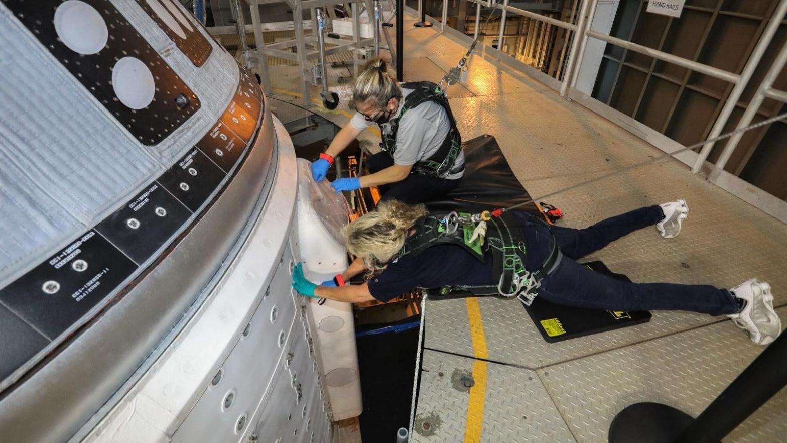 Boeing engineers attending to the glitchy Starliner, currently parked inside the Vertical Integration Facility (VIF) at Space Launch Complex-41.  (Image: Boeing)