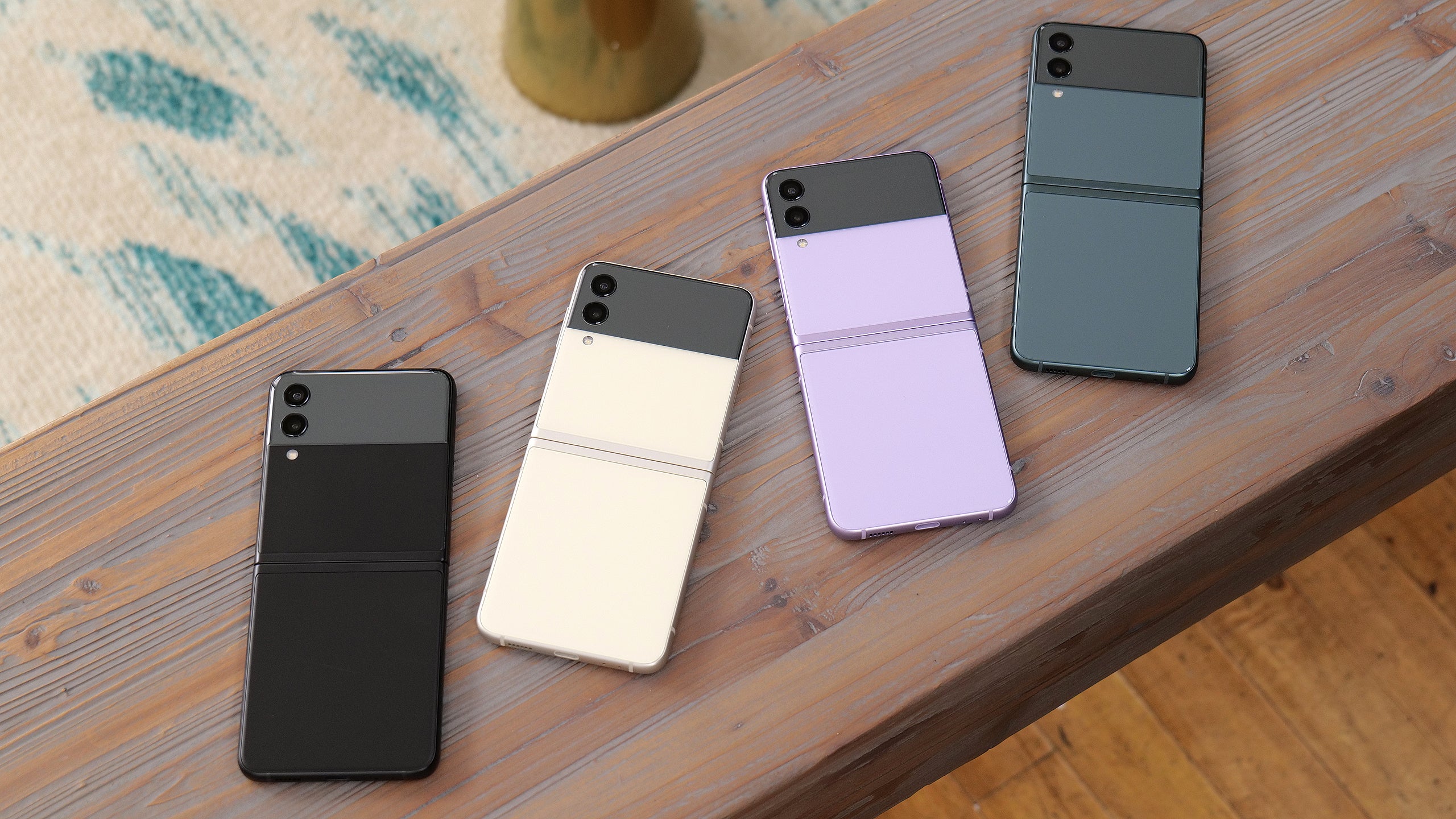 From left to right, we have black, cream, lavender, and grey variants of the Galaxy Z Flip 3.  (Photo: Sam Rutherford / Gizmodo)