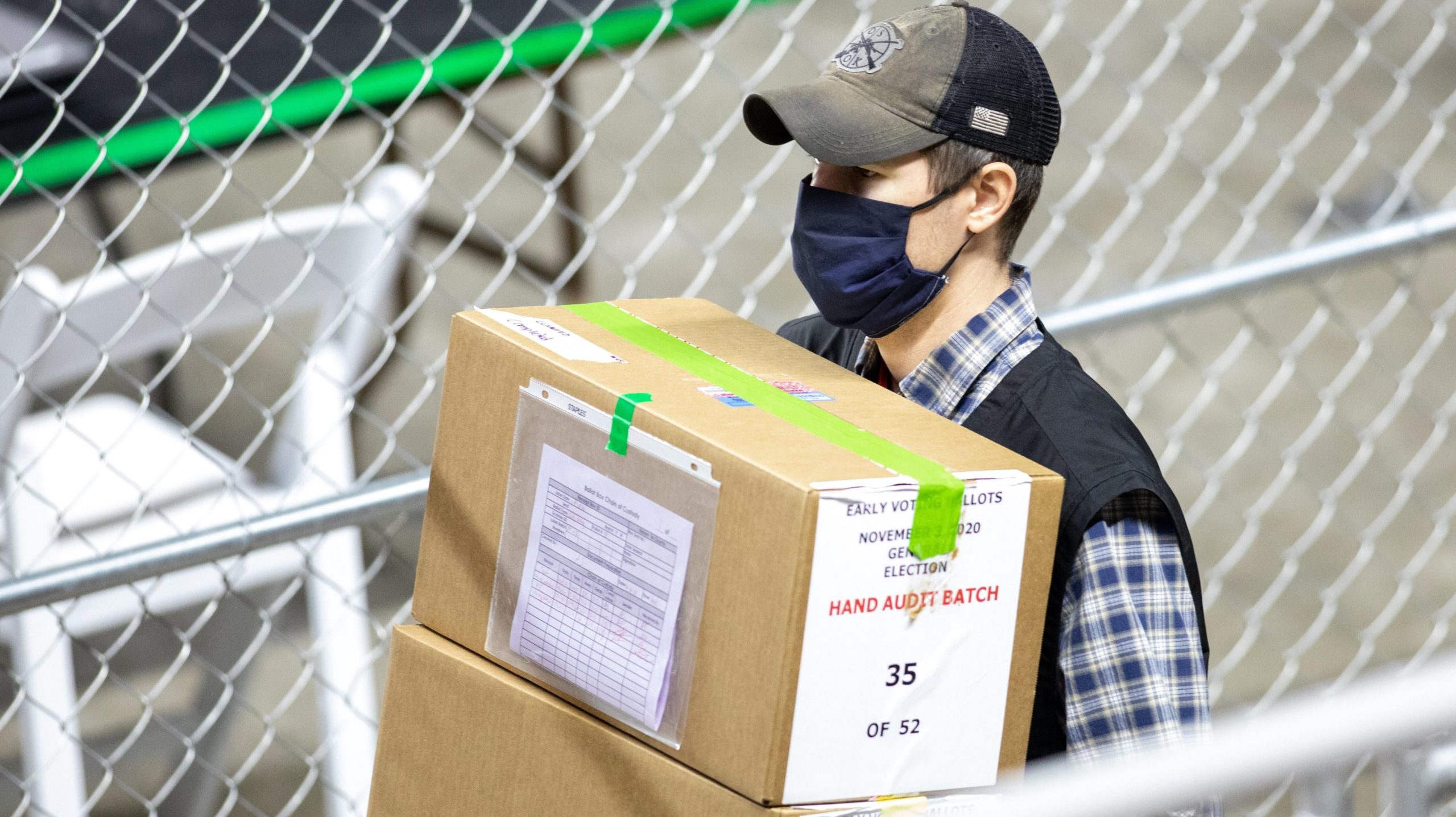 A contractor for Cyber Ninjas transporting ballots from Maricopa County's 2020 general election at Veterans Memorial Coliseum in Phoenix, Arizona, in May 2021. (Photo: Courtney Pedroza, Getty Images)