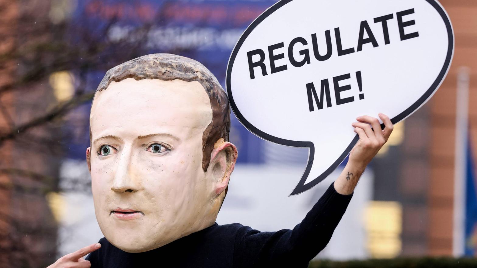 An activist wears a mask depicting Mark Zuckerberg outside the European Commission building in December. (Photo: Kenzo Tribouillard, Getty Images)