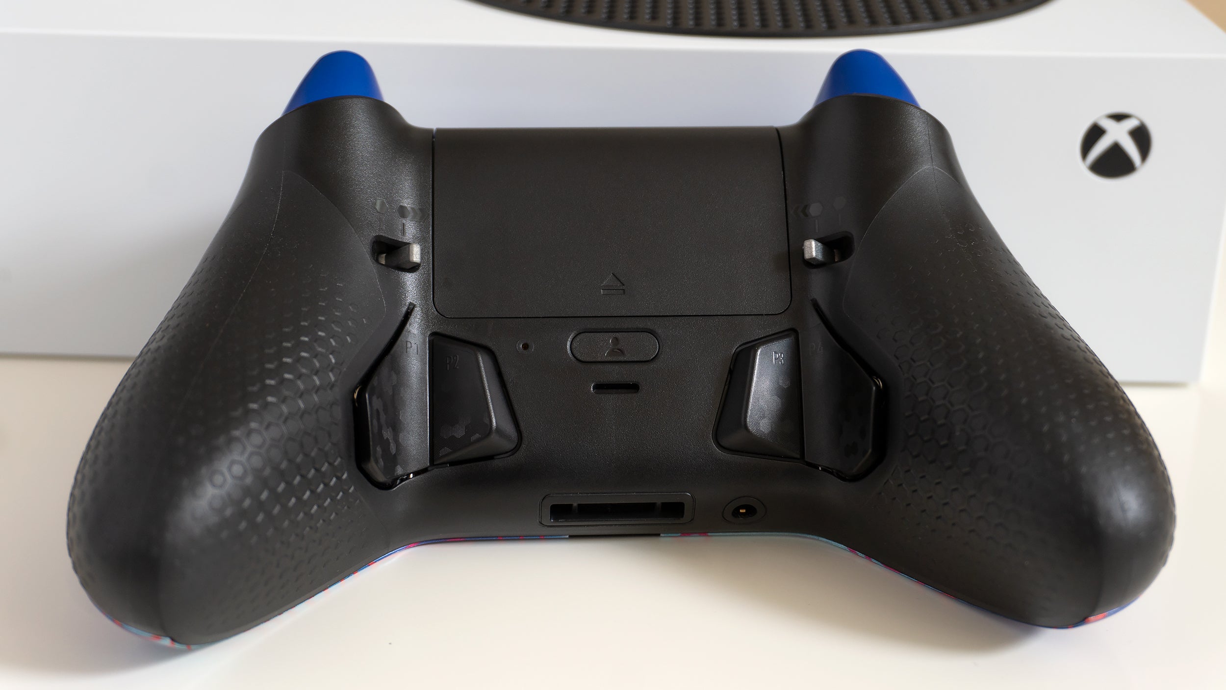 Instead of longer paddles, the Instinct and Instinct Pro now use smaller buttons that are easier to press when naturally holding the controller. (Photo: Andrew Liszewski - Gizmodo)