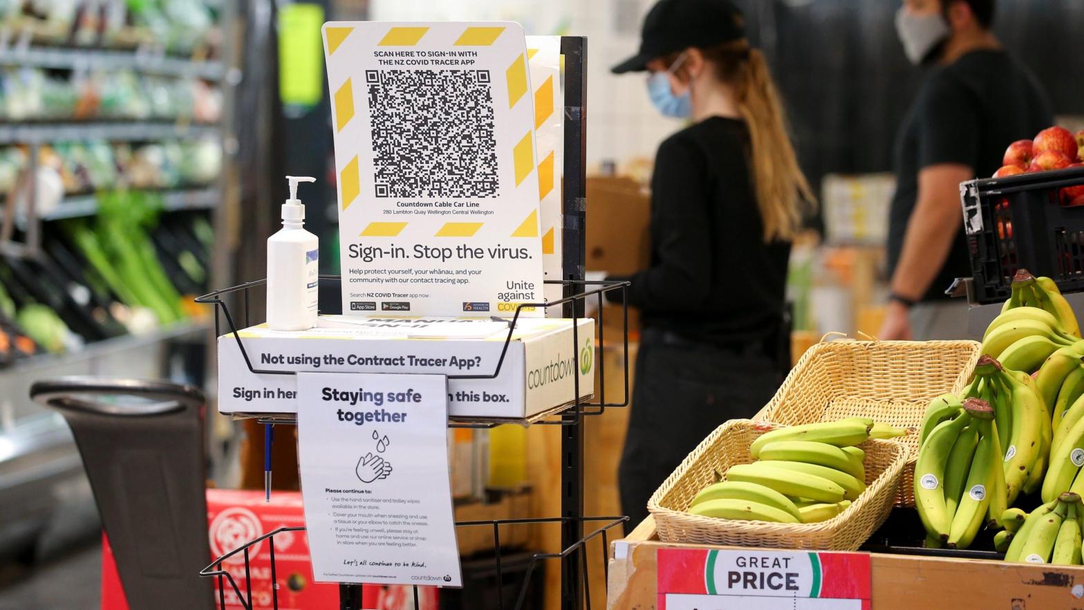 A New Zealand Covid Tracer App QR code and hand sanitizer sit at the entrance to a supermarket during the first day of a national lockdown on August 18, 2021 in Wellington, New Zealand. (Photo: Hagen Hopkins, Getty Images)