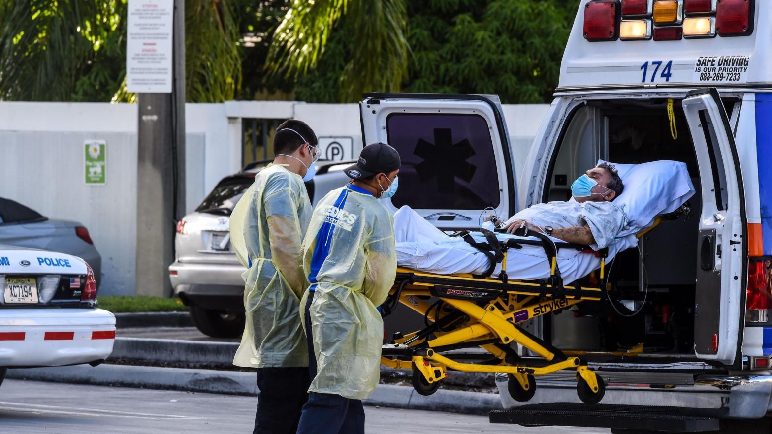 Medics transfer a patient on a stretcher from an ambulance outside of Emergency at Coral Gables Hospital where coronavirus patients are treated in Coral Gables near Miami, on July 30, 2020. (Photo: Chadan Khanna/AFP, Getty Images)