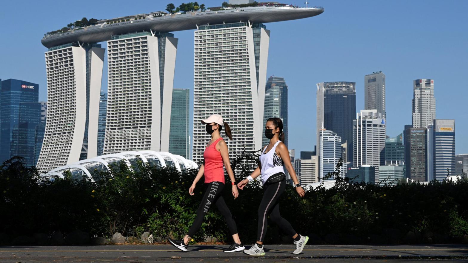 People make their way along the park connector at Marina Bay East in Singapore on August 9, 2021. (Photo: Roslan Rahman/AFP, Getty Images)