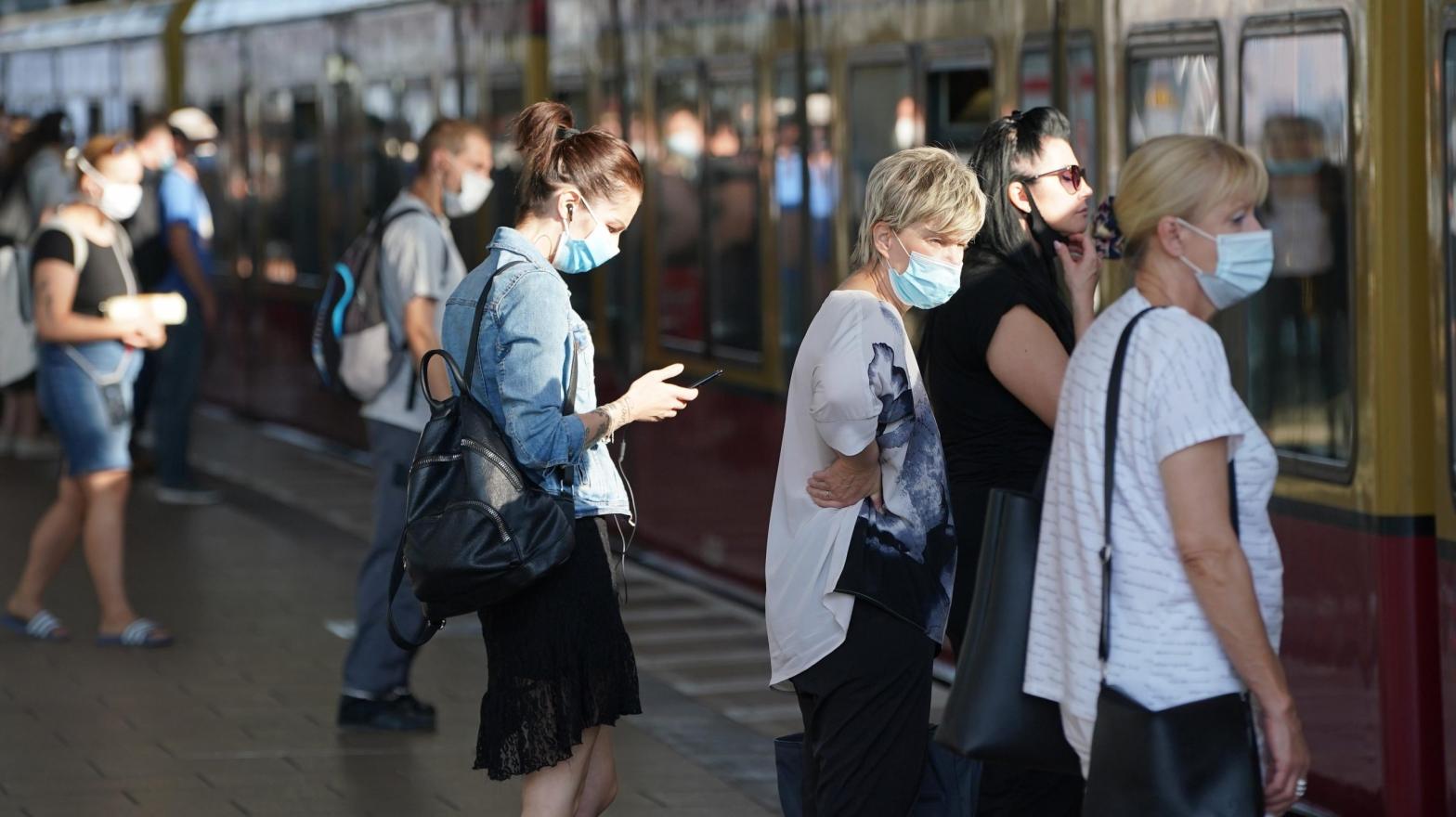 Commuters wearing protective face masks board a train on August 07, 2020 in Berlin, Germany. (Photo: Sean Gallup, Getty Images)