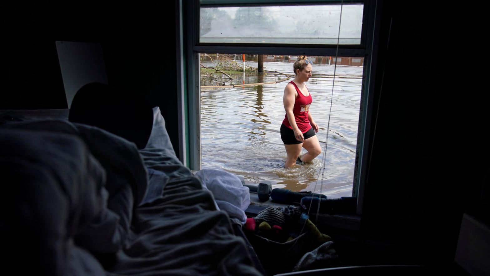 Emily Francois walks through floodwaters beside her flood damaged home in the aftermath of Hurricane Ida, Wednesday, Sept. 1, 2021, in Jean Lafitte, Louisiana. (Photo: John Locher, AP)