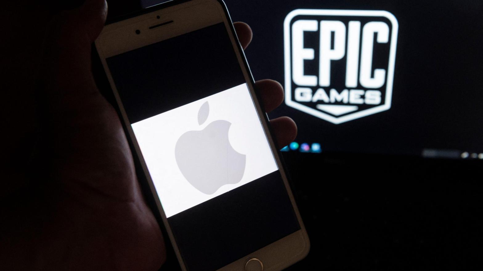 The Apple logo on an iPhone alongside the Epic Games logo on a laptop, April 2021. (Photo: Andrew Caballero-Reynolds / AFP, Getty Images)