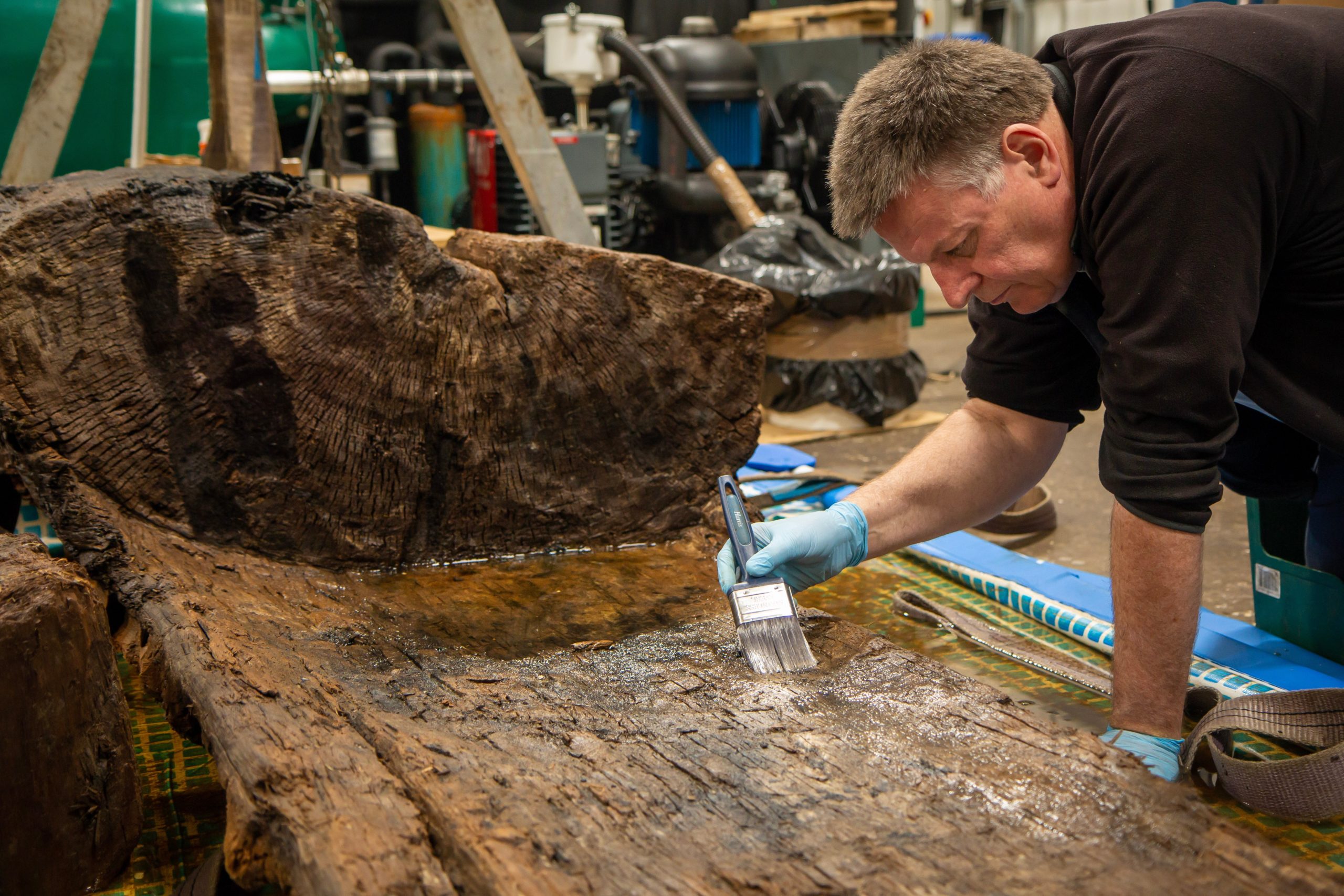 Ian Panter works on the 4,000-year-old oak coffin. (Photo: York Archaeological Trust)