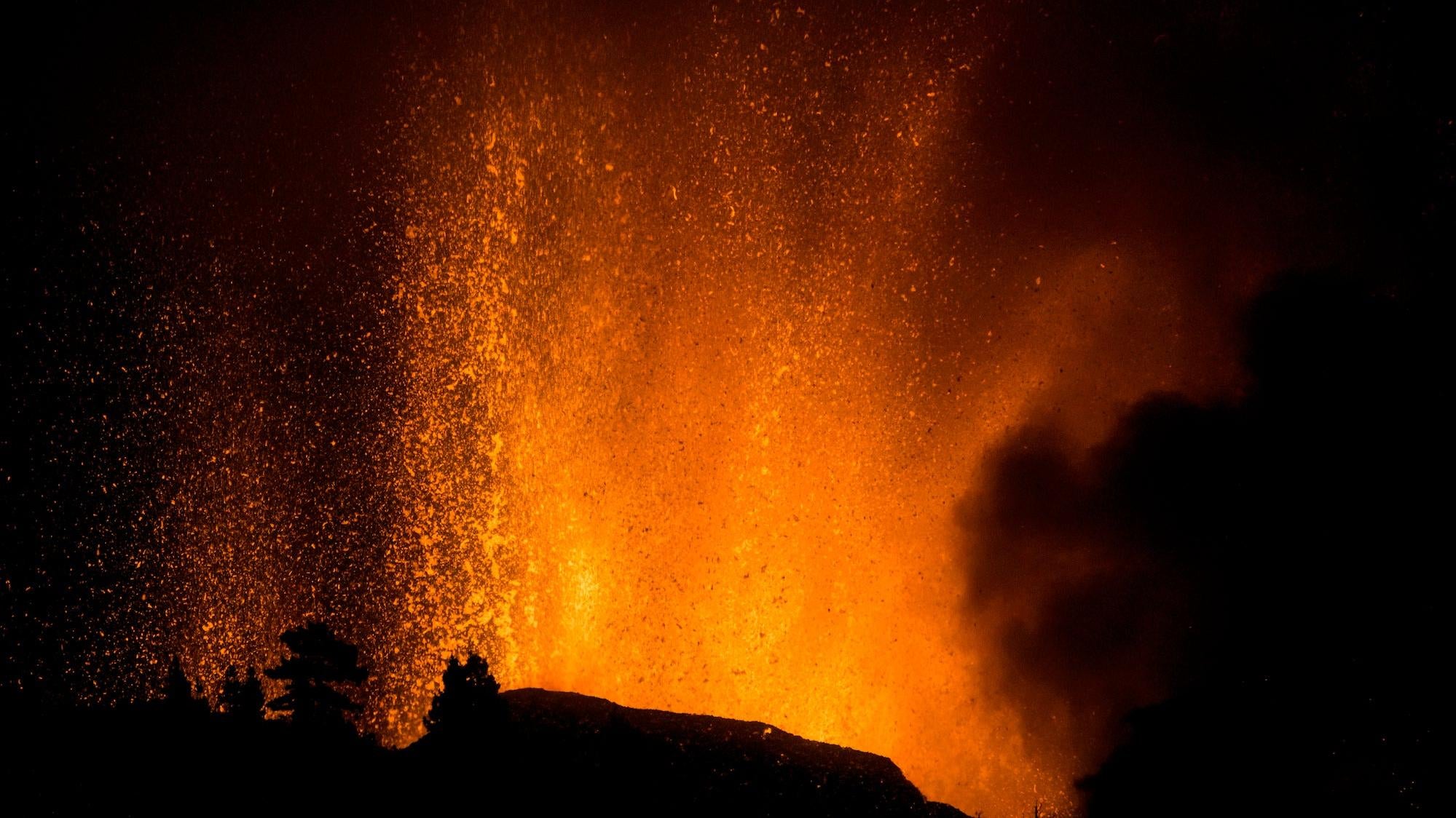Lava shoots into the sky from an eruption of a volcano at the island of La Palma. (Photo: Jonathan Rodriguez, AP)