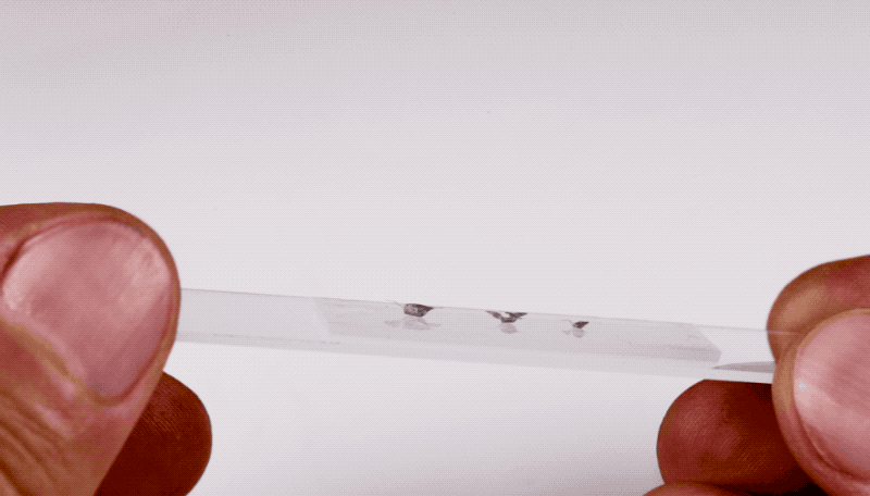 Three different sizes of microfliers mounted on glass.  (Gif: Northwestern University)